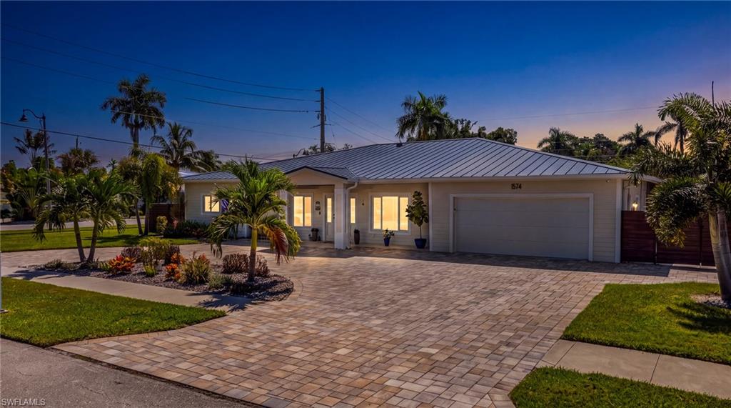 Welcome to a home designed for those who love to entertain, where high-end upgrades, thoughtful details and exceptional outdoor living come together in one impressive Southwest Florida property. NO FLOOD ZONE! This beautifully upgraded 3-bedroom, 2.5-bath home in the desirable McGregor area offers an outdoor entertainment space that truly sets it apart. The showpiece is the incredible outdoor kitchen and bar featuring premium BULL equipment, including a hibachi grill, stove and double stove, along with separate wine and beer coolers, 4 TRUE-brand kegerators, a freezer for ice cups, Culligan RO system with chiller, expansive island seating and a striking ceramic feature wall. Tongue-and-groove ceilings extend across the front and rear outdoor areas, firepit-creating a warm, upscale Florida atmosphere. 
Inside, you'll find ceramic tile throughout, KitchenAid appliances, a dedicated coffee bar with built in wine cooler, interior laundry room with utility sink, Culligan RO system with sink chiller, whole-house water softener and a tankless water heater. 5-zone surround-sound system allows each zone to be controlled separately from a phone, tablet or computer, while the whole-house camera system and wired alarm system add additional convenience and security. Major upgrades include a 2023 standing-seam metal roof, 2023 18-SEER HVAC system, two mini-split systems added in 2024, impact windows and doors, foam insulation, sealed soffits and electric hurricane shades with separate interior and exterior zones. The garage is finished with epoxy flooring and its own mini-split system.
This is more than a beautifully upgraded home—it's a property built for gathering, entertaining and enjoying the Southwest Florida lifestyle year-round. This house was made for football Sundays, birthday parties & family gatherings. Full upgrades list attached to mls