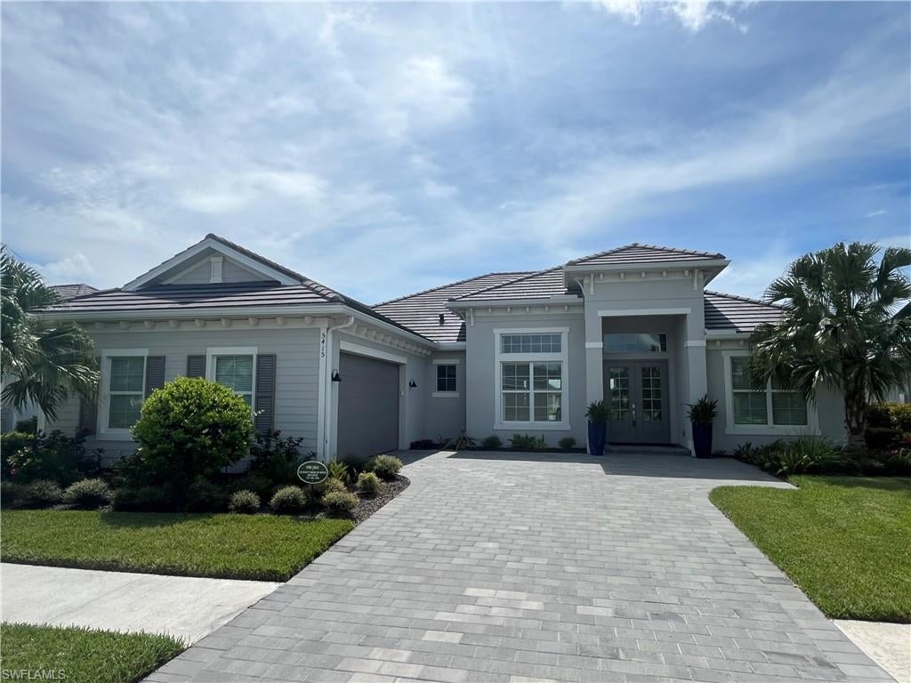 This stunning Bougainvillea II Model. 3 Bedroom + Study with Murphy Bed, 3 Full Baths, 2 Car garage home,  overlooking 2 lakes & the golf course is available to become your personal retreat in Paradise at The National Golf & Country Club of Ave Maria. This is arguably The Best Floor Plan & Lot that is available.
The purchase of this Home INCLUDES GOLF MEMBERSHIP.
This home has an elegant OPEN DESIGN with 12 FT. CEILINGS in the Great Room, Dining Room, Kitchen & Kitchen Nook.
From the moment you walk in the front door you will be taken by the grandness of the BLACK MARBLE floor to ceiling Fireplace wall, decorative floor to ceiling draperies, UNIQUE COUNTER TO CEILING WHITE MODERN OCTIGON BACKSPLASH in the Kitchen and Bar area, CUSTOM EBONY CABINETS, White Quartz Countertops throughout the home and Built-in Closets in the Owner's Suite. 
Access the Spacious Lanai with Heated Pool & Spa from the Great Room, Owner's Suite or Guest Suite where the sunset views are simply breathtaking.
These are just a few examples of what this Grand Home has to offer. You just have to SEE IT & FEEL IT for YOURSELF to FULLY APPRECIATE!