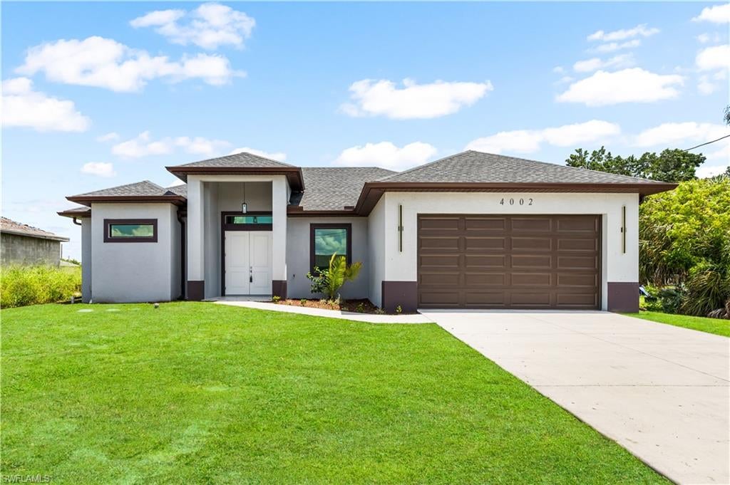 BEAUTIFUL BRAND-NEW 4 bedrooms, 2 bathrroms and 2 car garage IN LEHIGH ACRES! Featuring over 1,808 square feet of living area and 2,495 total square feet, this thoughtfully designed home offers 4 bedrooms, 2 bathrooms, and a spacious two-car garage. The open-concept floor plan seamlessly connects the living room, dining area, and modern kitchen, creating the perfect space for entertaining and family gatherings. The kitchen showcases white contemporary cabinetry, stainless steel appliances, a large island, and elegant white quartz countertops. The spacious primary suite features a walk-in closet, dual vanities, and a large walk-in shower. Additional upgrades include impact-resistant windows and doors, a large covered lanai, and modern light fixtures with three adjustable lighting tones, allowing you to create the perfect ambiance throughout the home. The oversized backyard provides plenty of room to build your dream pool and outdoor entertainment area. The garage also features a side access door and a window that brings in natural light, making the space brighter and more functional.Ideally located with easy access to I-75, State Road 82, and Gunnery Road, this stunning home offers convenience and modern living just minutes from SWFL International Airport, FGCU, shopping centers, restaurants, and everyday amenities. Don't miss this incredible opportunity to own a beautiful new construction home in one of Southwest Florida's fastest-growing areas!