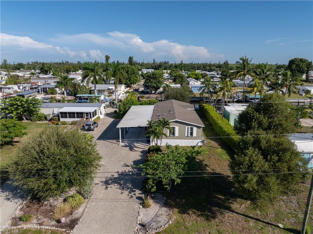 Welcome to Flamingo Bay!!! With almost 1400 square feet of living area, this gulf access home is situated on a full lot, featuring 2 bedrooms plus a den, 2 full baths, an oversized 1-car garage, and an open concept living/dining area with a large island. Keep your boat secured on your private 10,000 lbs. lift where you'll always be minutes away from Gulf waters. Go fishing early in the morning or sail into the sunset in the evening.  Whatever your interests are, tranquility awaits you at Pine Island. Schedule your private showing today.