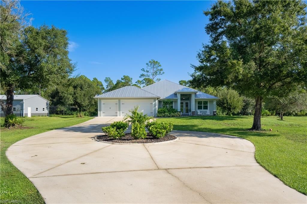 Welcome to your own private 5-acre retreat, tucked away on a quiet private road, yet incredibly convenient, just 5 minutes from I-75. AG-Zoned. Finding this much acreage, privacy, & functionality this close to the interstate is exceptionally rare. This meticulously maintained property features an inviting open-concept home, beautiful landscaping throughout, and an impressive list of upgrades designed for both entertaining & everyday living. Step outside to your own backyard oasis featuring a screened-in, heated saltwater pool and spa, less than 2 years old, thoughtfully designed with premium finishes. Luxury glass tile, upgraded Shell stone pavers that won't burn your feet, or your furry friend's paws. Independent heating systems for both the pool & spa provide year round comfort & flexibility. The guest suite features its own full bathroom with direct access to the pool and spa making it ideal for visitors and extended family. Outdoor upgrades include a patio TV feature wall, with a fireplace, upgraded variable-speed fans, and patio seating and dining furniture that stays with the home. A standout feature is the massive 1,800 sq. ft. (60x30) detached workshop/warehouse, ideal for a business owner, car enthusiast, hobbyist, or anyone needing substantial storage. It features three rolling bay doors, shelving, overhead and exterior lighting, electrical service, and a concrete ramp at the rear bay door. A separate double-gated entrance provides convenient access directly to the workshop. The 5 acres are fully fenced and lined with Areca palms and irrigation for added privacy, complemented by beautiful landscaping and a landscaped roundabout. Additional upgrades include a tiled living room fireplace feature wall, mini-split systems in the garage and guest suite, and upgraded electrical outlets & additional panel in the 3 car garage. Best of all, the toys are included! Two Can-Am 550 4-wheelers and an Axis 500 side-by-side are included, 72-foot batting cage, along with the patio furniture and in-pool lounge chairs. Five private acres, resort-style pool and spa, an 1,800 sq. ft. workshop, incredible privacy, and room to live, work, entertain, and play—this one truly has it all!