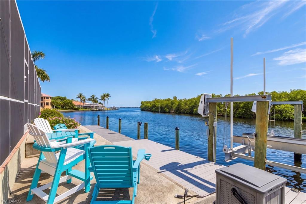 Welcome to your Gulf-access sanctuary in secluded Palm Acres, where waterfront living dreams come true! This remarkable home boasts stunning long water views stretching to the river and preserve, creating a serene backdrop for everyday living and entertaining. Step outside to discover an expansive pool area perfect for cooling off on sunny Florida days and hosting unforgettable gatherings with family and friends. This charming three-bedroom, three-bathroom home invites you to experience SW Florida living at its finest, complete with two  ensuites that provide privacy and comfort for the whole household. The heart of the home features a welcoming great room that flows effortlessly into the pool area, Recent updates throughout the home showcase thoughtful modernization while maintaining the character and warmth that makes this property truly special.  You'll enjoy the peace of mind that comes with a brand-new roof installed in 2023 and a recently updated HVAC system, ensuring your home runs smoothly year-round, while a whole-house generator and hurricane shutters to keep everything running even during unexpected weather events. The location is absolutely unbeatable—you're just minutes from the pristine sandy shores of Sanibel and Captiva beaches, convenient access to Health Park Hospital, nearby Publix and wonderful restaurants to explore. This is the ideal setting for anyone seeking the perfect blend of seclusion, convenience, and the authentic Florida waterfront lifestyle!