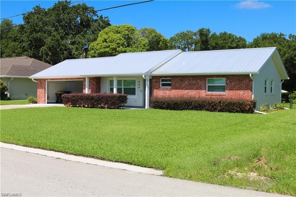 This beautiful updated 2-bedroom, 2-bath home offers direct access to a freshwater canal and lake, covered boat dock, boat lift, jet ski lift, and seawall-perfect for boating, fishing, or simply enjoying the peaceful view. Situated on a fenced lot with NO HOA, this move-in-ready home has been extremely renovated inside and out. Major improvements include a metal roof on both the home and boathouse, impact-rated windows and doors, remodeled kitchen and bathrooms, new HVAC and ductwork, updated appliances, new tile flooring throughout, fresh interior and exterior paint, gutters, driveway, walkway, screen porch, fixtures, water heater, well pump, irrigation pump, drain field, and more. The open kitchen features an island, bar seating, and stainless-steel appliances, while the spacious primary suite offers dual sinks and beautifully updated bathroom. Step outside to the large screened lanai overlooking the water, where you can relax or entertain year-round. Additional features include a 2-car garage, automatic sprinkler system, owned water treatment system with softener and filtration, laundry tub, fenced backyard and lush new landscaping. Whether you’re looking for a full-time residence, seasonal retreat, or waterfront gateway, this meticulously maintained Lake Placid property checks all the boxes