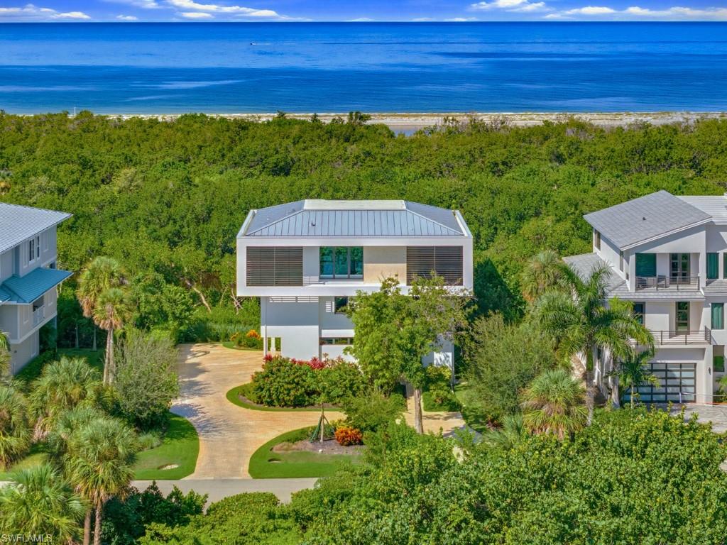 This remarkable residence combines contemporary architecture, elevated luxury, thoughtful engineering, and an unparalleled coastal setting to create an extraordinary private retreat within magnificent Hideaway Beach Club! Designed by award-winning Architect John Cooney with the intention of creating a true fortress, this exceptional custom home offers nearly 3,000 sf of air-conditioned luxury living spanning 3 levels. Completed in 2023, this contemporary architectural masterpiece features 3 bedrooms, 3-1/2 baths, a private office, elevator to all 3 levels, travertine flooring, high-end Miele appliances, exquisite finishes, neutral decor & breathtaking Gulf views. The top floor (main living level) showcases a sophisticated great room living space & primary bedroom suite that seamlessly transitions to an expansive outdoor terrace. Framed by a glass balcony, the terrace overlooks the Gulf, tranquil lagoon, with abundant wildlife, lush tropical vegetation & amazing sunsets--an extraordinary setting for entertaining or simply enjoying the natural beauty of Marco in a rarely found private setting. Masterfully constructed with concrete block on all floors and thoughtfully engineered for exceptional storm resilience, the residence incorporates an impressive array of protective features, including PGT thermal-insulated windows rated up to 170 mph, a Kohler whole-home generator, a 1,000-gallon propane tank, a concrete aqueduct system directing rooftop water to underground drainage, eliminating the need for gutters & downspouts. The middle floor--the first living level--is approximately 18' above sea level with 2 guest suites, an office & laundry, while the main living floor sits approximately 28' above sea level. Ideally situated for private views within the world-class, guard-gated beachfront community of Hideaway Beach Club, the home is conveniently located near beach access & kayak storage area. Residents can also enjoy a quick golf-cart ride to the Beach Club, offering Marco's best formal & casual beachfront dining, a community pool & hot tub, 2-miles of beach & the brand-new, state-of-the-art Sports Center. It features top-of-the-line fitness equipment, group exercise studios, personal training, multiple golf simulator bays, physical therapy, massage services, saunas, beautifully appointed locker rooms, a pro shop, golf/tennis pros, drink bar, fabulous views of the brand new golf course & more. Hideaway is one of Marco Island's true gems & offers far more than a place to live--it is a lifestyle. Residents enjoy a guard-gated entry, a new 9-hole golf course, tennis, pickleball, and an exceptional array of recreational amenities--all designed to complement a perfect luxury coastal lifestyle!