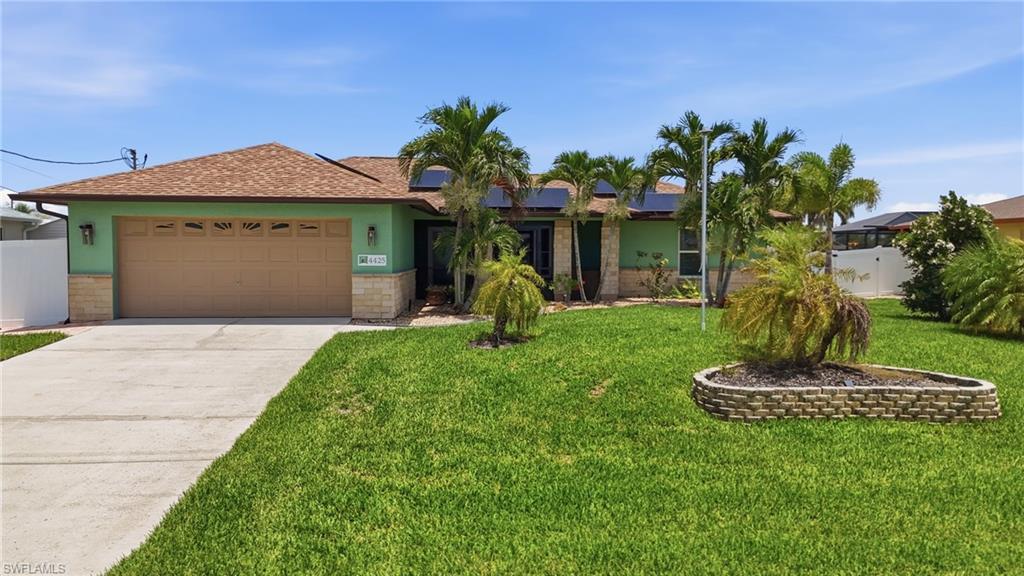Welcome to 4425 SW 14th Pl, a beautifully updated 3-bedroom, 2-bath home with a 2-car garage, perfectly situated in Southwest Cape Coral. Thoughtfully renovated inside and out, this move-in-ready residence offers the ideal blend of modern upgrades, timeless style, and the relaxed Florida lifestyle you've been searching for.

Step through the screened front entry into a bright, open great room where nearly every living space enjoys views of the sparkling saltwater pool. The remodeled kitchen features granite countertops, a stylish tile backsplash, stainless steel appliances, a pantry, breakfast bar, and additional cabinetry in the dining area with accent lighting, creating the perfect space for everyday living and entertaining.

The true highlight is the private backyard oasis. Relax on the extended paver lanai with two roll-down hurricane screens, a mounted TV, and a heated saltwater pool featuring LED lighting and a tranquil waterfall. Surrounded by tropical landscaping and a fully fenced backyard, this outdoor retreat is perfect for entertaining, relaxing, or letting children and pets play safely.

The spacious primary suite and guest bedrooms all include walk-in closets, while the third bedroom offers the flexibility to serve as a home office or den. Built for peace of mind, the home has never flooded and features impact windows, an impact-rated front door and sliding glass door, plus a hurricane-rated garage door.

Extensive updates make this home truly turnkey. Recent improvements include a new pool heat pump (2024), exterior paint with stone accents (2023), a custom Murphy bed with built-in bookcase (2022), and in 2021, solar panels, a vinyl privacy fence, new pool cage, expanded paver pool deck, Hayward pool pump, Hunter irrigation system, updated laundry room with cabinetry and stainless sink, Samsung stackable washer and dryer, and motorized hurricane screens on the lanai. In 2020, the home received a new roof, gutters, Trane A/C with new ductwork and smart thermostat, impact windows and doors, a whole-house water softener, reverse osmosis system, and Samsung stainless steel appliances. Luxury vinyl plank flooring, updated lighting, remote-controlled ceiling fans, and no carpet complete the interior.

For added value, assessments and solar panels are paid in full, and the transferable flood insurance policy offers potential savings for the new owner. Conveniently located near Cape Harbour, waterfront dining, shopping, grocery stores, medical offices, and miles of sidewalks for walking and biking, this meticulously maintained home showcases exceptional pride of ownership. Whether you're looking for a full-time residence or seasonal retreat, this Southwest Cape Coral gem is ready to impress. Schedule your private showing today!
