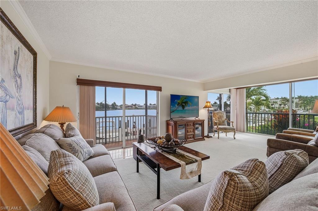 This two-bedroom, two-bath rarely available corner end-unit offers front-row views of Moorings Bay and is ideally directly across from two beach access points. Ideal for boating enthusiasts, you are just near the on-site boat slips with quick Gulf access. Notable features include a wall of sliding glass doors that fill the space with natural light, a screened lanai, a walk-in closet and stainless-steel appliances. This residence is an exceptional opportunity for a buyer to create their custom retreat in one of Naples desirable waterfront locations. Harbour Cove residents enjoy a bayfront pool, grills and barbecue area, tiki hut, fishing pier, bike storage, vehicle wash area and opportunity to lease a boat slip with a lift, when available. For investors, the property allows three leases per year with a 60-day minimum. Conveniently just north of Harbour Drive, Harbour Cove offers effortless access to the beach, Moorings Golf and Country Club, and the waterfront shopping and dining of Venetian Village.