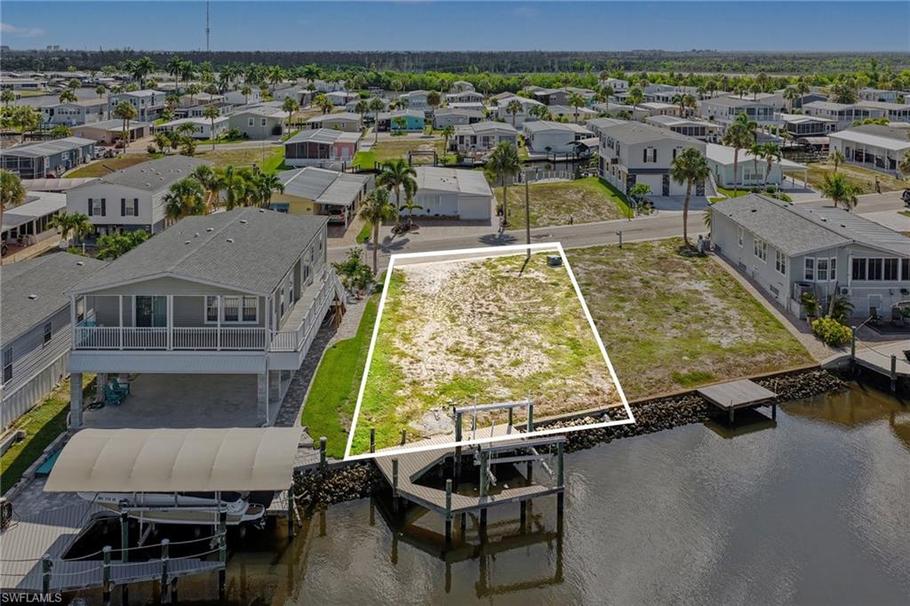 Build your dream home in this sought-after 55+ waterfront community on the saltwater side of Bayside. This exceptional homesite offers direct Gulf access and features a composite dock with a 10,000-pound boat lift, making it ideal for boating enthusiasts. Enjoy watching dolphins play right from your backyard while taking in the beautiful waterfront setting.Located just minutes from Fort Myers Beach and Sanibel Island, you'll have easy access to pristine beaches, restaurants, shopping, grocery stores, and everyday conveniences.
Residents enjoy an active Florida lifestyle with amenities including a community pool, tennis courts, bocce, and more. The low HOA fee covers water, internet, garbage service, and access to community amenities.
With only 2.5 miles to the beach and endless opportunities for recreation on and off the water, this is the perfect place to build your custom home and enjoy Southwest Florida living at its finest.