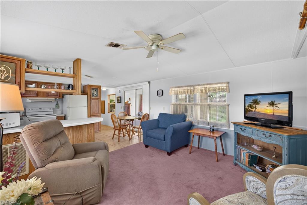 Fantastic opportunity to own a charming 2-bedroom, 2-bathroom manufactured home in the highly sought-after 55+ community of Bonita St. James Village. Built in 1991, this property uniquely stands out with its oversized, irregular lot, offering extra yard space and added privacy. The exterior features excellent curb appeal with a long, paved driveway leading to a covered attached carport. Inside, you'll find a highly functional floor plan perfectly designed for easy Florida living. Located in a quiet, beautifully maintained 118-unit active adult neighborhood, residents enjoy access to a community pool, spa, and clubhouse. Best of all, this prime location places you just minutes from the charm of historic downtown shopping and dining, and a short 6.5-mile drive to the pristine sands of Bonita Beach. Home does need a little extra cleaning in the enclosed porch area from smoking, other than that it's premium lot space, and unbeatable location make this home a must-see!