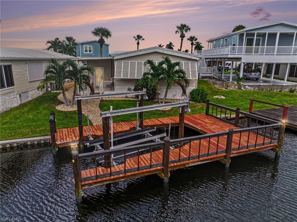 Beautifully updated 2-bedroom, 2-bath home in Bayside Estates, showcasing meticulous attention to detail throughout. The property features a covered carport with electric hurricane shutters, professional landscaping, inviting canal views, and a covered back patio perfect for enjoying the Florida setting. Inside, built-in buffet cabinetry and thoughtful updates create a comfortable and stylish living space. Bayside Estates offers a low HOA and an array of community amenities and activities, including dinners, live bands, boating opportunities, and social gatherings. Conveniently located approximately 2.5 miles from the island, with easy access for biking to the island’s restaurants and entertainment, including Margaritaville. Whether relaxing at home, enjoying time on the water, or exploring nearby dining and entertainment, this beautifully maintained property provides an opportunity to embrace the Southwest Florida lifestyle.