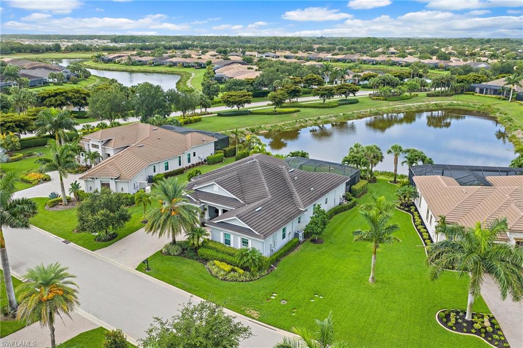 Welcome to an exceptional opportunity in Torrey Pines at Verandah, one of the community’s most sought-after neighborhoods, where generous living spaces, tranquil water views and an impressive indoor-outdoor lifestyle come together. Built by Kolter Homes in 2016 with concrete block construction, this beautifully appointed “Somerset Hill” design offers just under 3,000 square feet of living space, with three bedrooms, a bedroom/study, a bonus/flex room and a spacious three-car garage. High ceilings, abundant natural light and an open, thoughtfully designed floor plan create an immediate sense of space and comfort throughout the home. At the heart of the residence is an expansive kitchen designed for both everyday living and entertaining. A large granite island with generous seating anchors the space, complemented by extensive cabinetry, stainless steel appliances, pendant lighting and natural gas. The kitchen flows effortlessly into the surrounding living and dining areas, creating an inviting gathering space with views toward the outdoors. The primary suite provides a private retreat with a tray ceiling and peaceful views, while the spacious primary bath features dual vanities, a soaking tub and an oversized walk-in shower. The bedroom/study has been transformed into an impressive custom-designed home office with extensive built-in cabinetry and workspace, ideal for today’s work-from-home lifestyle. The outdoor living space is where this home truly shines. An expansive covered lanai opens to a screened chlorine pool and spa, surrounded by a spacious paver deck and lush tropical landscaping. A dedicated outdoor kitchen and dining area makes entertaining effortless, while serene water views provide a beautiful backdrop for morning coffee, afternoon swims and evenings spent outdoors. The combination of covered and open-air living spaces creates a private, resort-inspired setting designed to be enjoyed year-round. Additional highlights include an in-house laundry room with a natural gas dryer, a generous .31-acre lot and mature landscaping. The home is located in a non-flood zone, while the seller has also maintained flood insurance for additional peace of mind. Beyond the residence, Verandah offers the quintessential Southwest Florida lifestyle with two championship golf courses, tennis, pickleball, bocce, a fitness center, community pool, dog park, kayaking along the Orange River, and more than nine miles of scenic walking and biking trails. All of this is conveniently located just minutes from Downtown Fort Myers and the Caloosahatchee River. With its spacious floor plan, impressive outdoor entertaining areas, private pool and spa, custom office, three-car garage and picturesque water setting, this Torrey Pines residence delivers an exceptional combination of comfort, sophistication and Southwest Florida living.