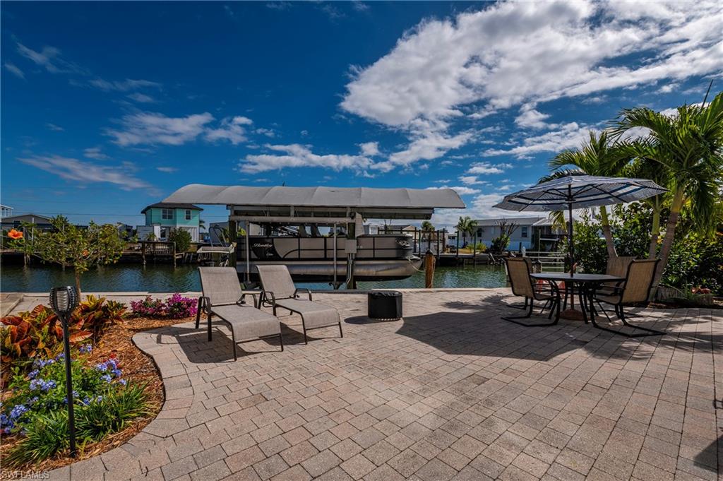 YOUR SOUTHWEST FLORIDA WATERFRONT LIFESTYLE STARTS RIGHT HERE! Imagine waking up, pouring your coffee and stepping outside to peaceful canal views before deciding whether the day calls for boating, fishing, a trip to Fort Myers Beach or simply relaxing waterside at home. Located in the desirable 55+ waterfront community of Nancy Lane on San Carlos Island, this spacious 3-bedroom, 2-bath home offers nearly 1,900 square feet of living space and Gulf-access boating right from your backyard.
The star of this property is the waterfront. Your private composite dock and covered boat lift feature water and electric service, making it easy to keep your boat ready for spontaneous days on the water, sunset cruises and fishing adventures. After a day of boating, unwind on the expansive deck or paver patio and enjoy the tropical surroundings and laid-back island atmosphere.
Inside, the bright and inviting floor plan offers plenty of space for both everyday living and entertaining. The kitchen features updated cabinetry, stainless steel appliances and a breakfast area, while the open living and dining spaces flow easily into the Florida room overlooking the water—an ideal spot for morning coffee, cocktails at sunset, reading or simply watching the boats go by.
Additional features include vinyl flooring, indoor laundry, generous storage, a newer A/C installed after Hurricane Ian, tankless water heater and wiring for a 30-amp electric vehicle charger. The split-bedroom layout offers added privacy, and the primary suite features a walk-in closet and private bath. Furniture is negotiable, allowing for an easier transition into your Florida getaway or full-time home, and the boat is available separately.
And the location is hard to beat. You're just minutes from Fort Myers Beach, with boating, fishing, waterfront dining, shopping and everything that makes Southwest Florida living so special close at hand.
Whether you're searching for a seasonal escape or a full-time waterfront home, 23 Nancy Lane delivers what so many buyers come to Southwest Florida looking for: space, water, a boat in the backyard and the freedom to enjoy the coastal lifestyle every single day.
