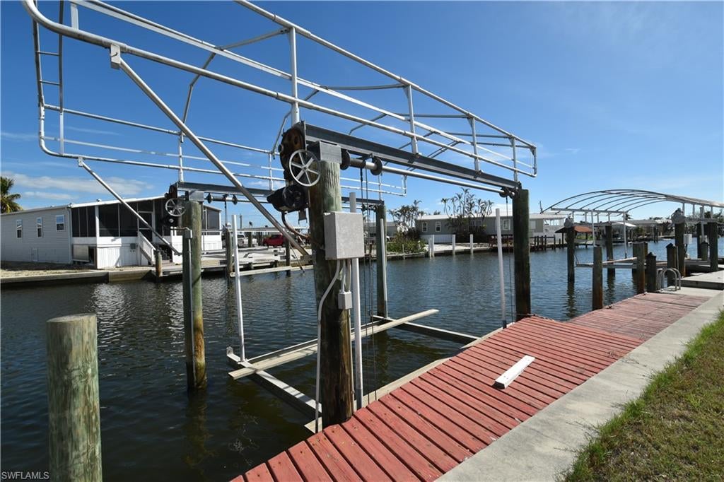 OWN your own land AND have a water view and A boat dock!!! Margaritaville and the bustling Times Square area just a 10 block walk or bike ride. This large lot has a private boat dock with a 10,000 lb. lift. Just minutes to the back bay to catch that yummy meal. Still have time for fun after a beach or boat day? Head to Parrot Key, Doc Fords, Dixie Fish House, Bonita Fish House. Just 5 blocks either way. Key West Express is just down the street. Take a day trip without the worries of driving over there in heavy season and parking. This over 55 community is a beautiful street with the friendliest people around. Build your dream home or your paradise vacation on YOUR OWN LOT. Come and live the beautiful Florida lifestyle! Upgraded city water/sewer system coming in future.