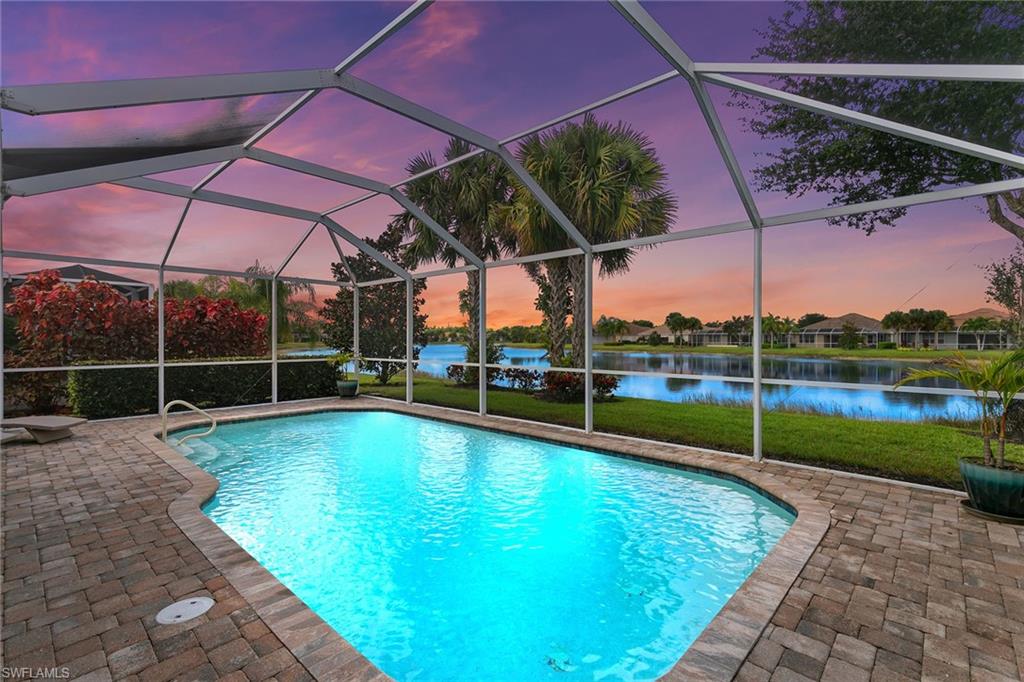 This beautifully appointed Tifton model features three bedrooms plus a spacious den and two full baths. The residence offers a paved lanai with sparkling saltwater pool that overlooks a tranquil lake, providing the setting for enjoying spectacular stunning sunsets from the comfort of your screened lanai. Wonderful open concept design seamlessly connects the eat-in kitchen, breakfast bar, walk-in pantry, formal dining area and living room, making it ideal for entertaining guests. Tiled flooring runs throughout the entire home, adding to its modern appeal. The split bedroom plan offers privacy for owners and guests, with the primary suite set apart from the guest bedrooms which includes an en-suite bath featuring double sinks, a soaking tub, walk-in shower and a spacious walk-in closet. Separate laundry room is in the house and generous den area with doors for privacy, ideal for a home office or quiet retreat. Residents of Verona Walk enjoy access to an impressive array of amenities with Har-Tru tennis courts, bocce, pickleball and basketball court, fitness center, two pools, including a lap pool, over 22 miles of recreational and biking paths, 24-hour guarded gate for security, onsite post office, travel agency, salon, car wash and café, Full-time activities director, and multiple community rooms and a library offering plentiful entertainment options. It is conveniently in downtown Naples's 5th Avenue offering an abundance of art galleries, fine dining, shopping and stunning sandy white beaches. Near Marco Island and easy access to Interstate 75. HOA dues include lawn care and irrigation, basic cable TV. This is more than just a home, it's a way of life.