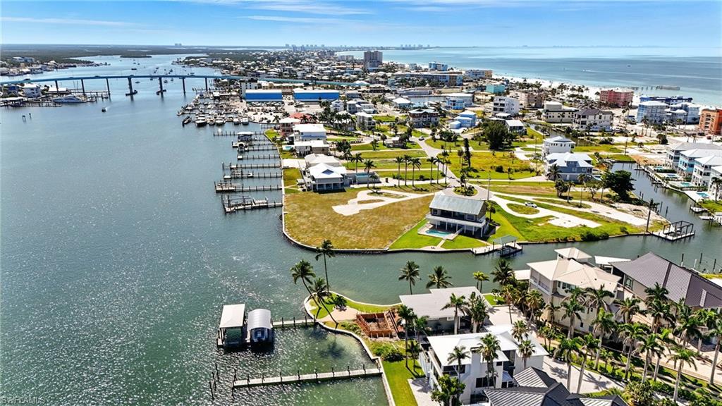 HUGE PRICE REDUCTION! Mother Nature’s Playground Meets the Ultimate in Luxury—Your future Estero Bay estate begins here. Discover a once in a lifetime opportunity to own a pristine, sprawling waterfront parcel on the prestigious North End of Estero Bay. This large, vacant lot offers nearly 90 feet of direct waterfront access with Gulf access just steps from your front yard—perfect for boaters seeking both convenience and exclusivity. Located on a peaceful cul de sac within the exclusive Matanzas Court neighborhood, this property provides the perfect blend of seclusion and vibrant island living. Imagine waking up to breathtaking sunrises over peaceful waters, enjoying evening strolls along the endless beach, and having effortless access to the Gulf from your own backyard. The seawall spans 89 feet across the rear of the property, Enjoy the North End location with just a short 5-10 minute walk to Times Square, Margaritaville, beachy restaurants, shops, and nightlife. The dedicated turn lane from the Matanzas Bridge ensures seamless high season access. Seeking a larger estate? The connecting Bayfront lot, (MLS #2025007037) with approved plans offers the opportunity for a larger footprint—perfect for creating an expansive compound or multiple residences. Elevate your living with direct access to the Gulf, unmatched privacy, and endless natural beauty—all within reach of Southwest Florida’s most vibrant hotspots. Imagine hosting unforgettable gatherings, indulging in picturesque sunrise mornings, or exploring the Gulf’s islands at your leisure. This is more than just land—it’s a rare opportuntiy to craft a custom coastal retreat beyond ordinary expectations. With over 15 commercial projects approved or underway across the island, now is the ideal moment to secure this special waterfront opportunity! SELLER FINANCING is available.