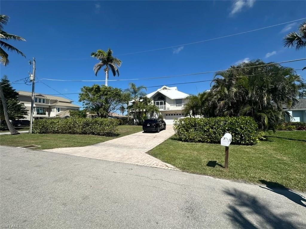 Come and see this spectacular home on Isle of Capri. Just minutes to Marco Island and within a short drive to all that Naples has to offer, this is one of the best areas in Southwest Florida by far. This three story home is waterfront home with no fixed bridges is located on the best side of Capri with quick and easy access to the Gulf. The home is on pilings and stunning bright remodeled Kitchen with huge Island. The views from all the windows facing the canal provide amazing views and spectacular sunsets. Directly off the living room on the main floor through the wall of sliding doors is a huge wrap around deck that is surrounded by the screened in patio area provide the ability to use it year around. The home has three bedrooms on the main floor - each with their own full bathroom. The top floor has an open loft area with two closets currently being used as a bedroom but is a very versatile space.  There is also a deck off of the loft area with amazing 180 degree views.
The ground floor has a two garage and a grand breezeway that is also screened in. As a bonus there is an efficiency off of the Breezeway with kitchen area and its own full bathroom. This is located directly adjacent to the pool area which is great for entertaining. The large heated pool has a waterfall feature and hot tub. The seawall is concrete and in great condition, the dock has a boat lift which was recently serviced and the dock has power and water. Behind the boat lift area are two 10000lb whips and roughly 20 plus feet to dock an additional boat behind the lift. 
The property is very private and surrounding by mature landscaping and it's located on a quiet street with great neighbors. This is a must see in Capri.