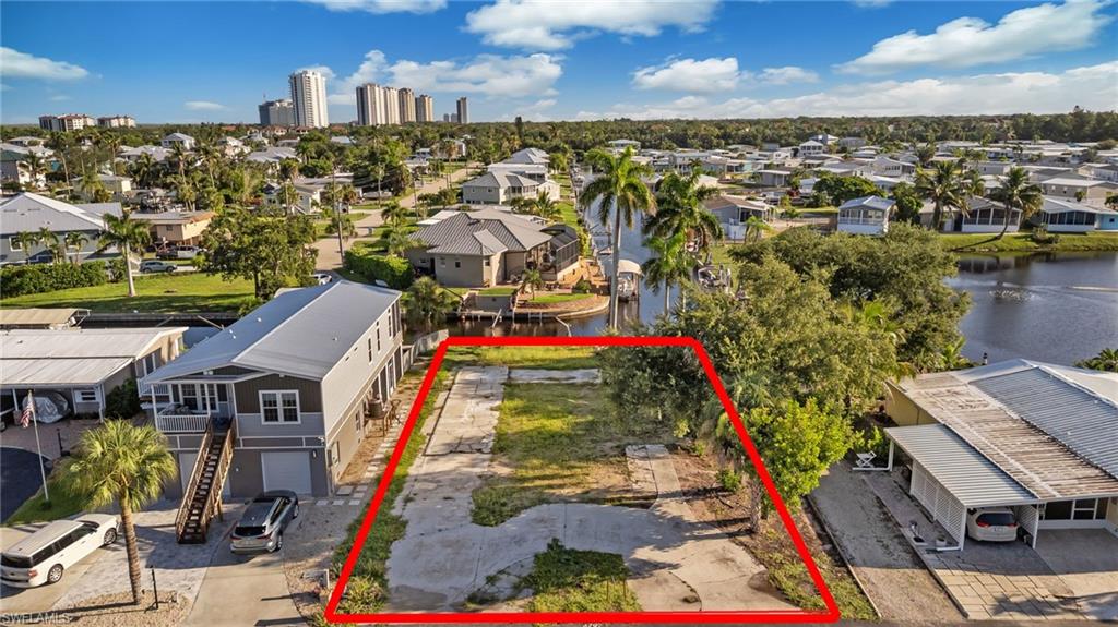 DIRECT GULF ACCESS VACANT LOT IN SPRING CREEK VILLAGE! Build your coastal dream home on this prime 0.22-acre waterfront lot (9,714 sq ft) offering stunning, unobstructed views of navigable Spring Creek and lush mangrove preserves. Boaters and outdoor enthusiasts will love the existing private dock equipped with a boat lift and canopy cover—get on the water instantly! Cruise in just 5–10 minutes out to Estero Bay, or ~15 minutes to New Pass, Lovers Key, Dog Beach, and the open waters of the Gulf of Mexico. Frequently spot dolphins and manatees right from your backyard. Central water, sewer, electric, and cable are ready at the site. Situated in the vibrant 55+ Hawaiian-inspired community of Spring Creek Village, where you own the land with remarkably low HOA fees. Enjoy resort-style amenities including a clubhouse, heated pool & spa, tennis, pickleball, bocce, boat ramp, boat storage, kayak launch, and a stocked fishing lake. Unbeatable location minutes from Coconut Point, dining, golf, and RSW Airport!