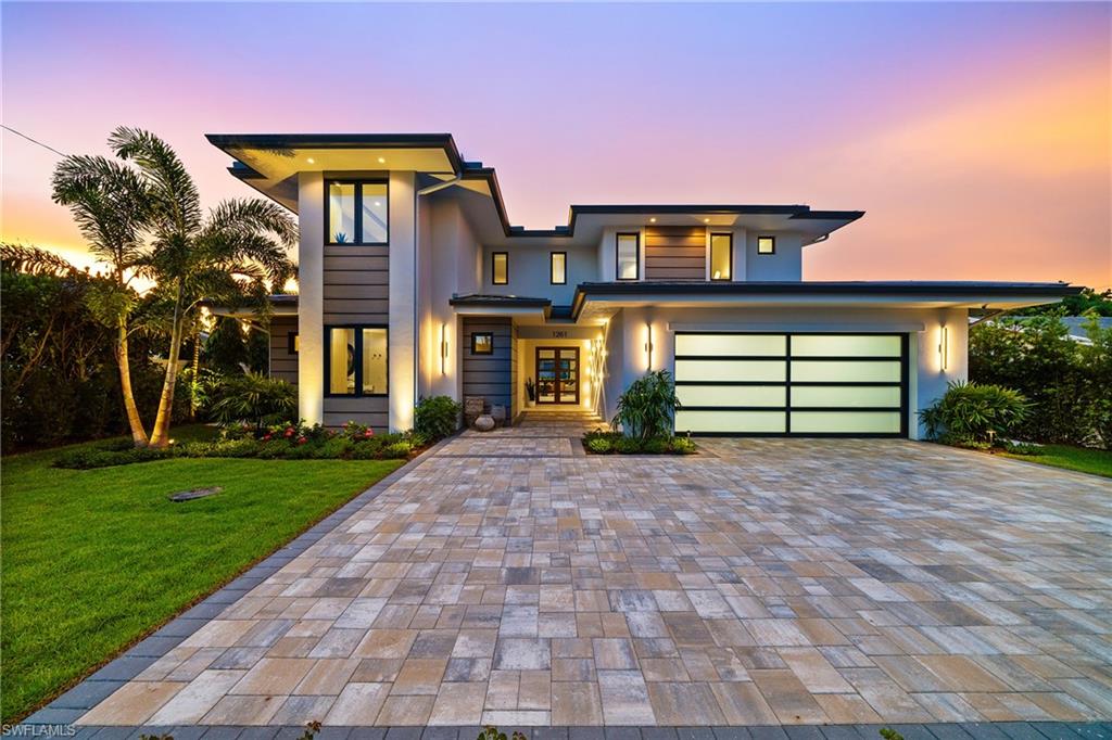 Renowned award winning custom home builder Sea Castle Development partnered with architect Ashmore Design to bring together a distinct offering in Lake Park unlike any other. Effortlessly blending elegance with livability, this extraordinary residence offers refined comfort across 3,766 square feet of sun-filled living space. This nature inspired home features an open-concept floor plan, soaring ceilings, and curated designer finishes throughout every inch. The chef’s kitchen is outfitted with a top-tier Thermador appliance package, while the summer kitchen boasts premium XO appliances—ideal for seamless indoor-outdoor entertaining. With natural elements present throughout the home, the backyard oasis lures you with its charm. Featuring multiple entertaining areas, one being shaded by a motorized pergola & the other fitted with electric screens & shutters – there is more than enough space for any type of gathering. The first-floor primary suite delivers comfort and convenience, while upstairs, a bedroom and two additional en-suites surround the spacious loft and a private balcony. Additional highlights include an elevator, hurricane impact windows and doors, engineered white oak Real Wood flooring, stunning designer tile work, sonos sound system throughout, propane heated saltwater pool / spa, & 24kw generator with automatic transfer switch. Offered fully furnished, this exceptional home is move-in ready and ideally located just minutes from Naples’ white-sand beaches, shopping and world class dining. Ready for immediate occupancy.