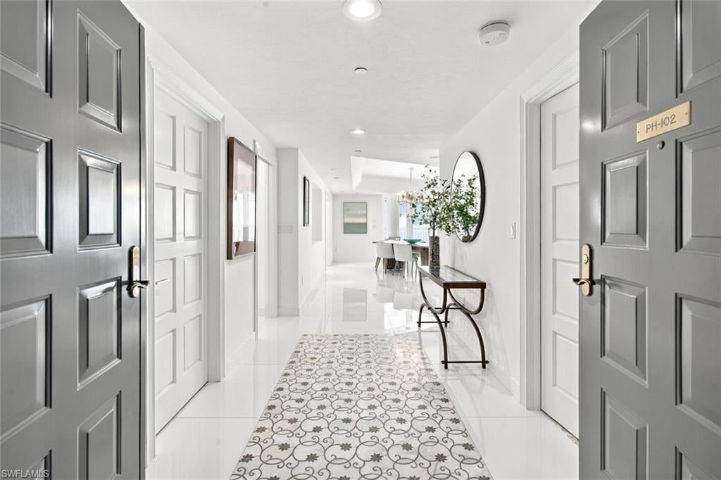 Must see to appreciate! An extraordinary sense of elegance and serenity greets you upon entering this chic residence. Bathed in natural light and framed by breathtaking unobstructed views of the Gulf, bay, and city skyline, this exquisitely renovated penthouse is a rare expression of refined, peaceful coastal living. Designed for both sophisticated entertaining and effortless comfort, the residence features a chef’s kitchen with premium appliances, generous wine storage, expansive living spaces, two beautifully appointed bedrooms, three baths, and a versatile family room ideal as a den, office, or third bedroom. A private three-car garage adds an exceptional level of convenience and exclusivity. Outside, marvel at the sweeping azure Gulf waters, spectacular sunrises and sunsets, and captivating evening views that extend south toward Marco Island.  Le Ciel Park Tower has been thoughtfully reimagined, with newly renovated grounds and common areas reflecting a sophisticated coastal aesthetic. Resort-caliber amenities include 24-hour security, fitness and social rooms, yoga/Pilates studio, guest suites, tennis courts, and a beachside pool, all impeccably maintained at one of the area’s most coveted beach addresses. Dock is sold separately.
