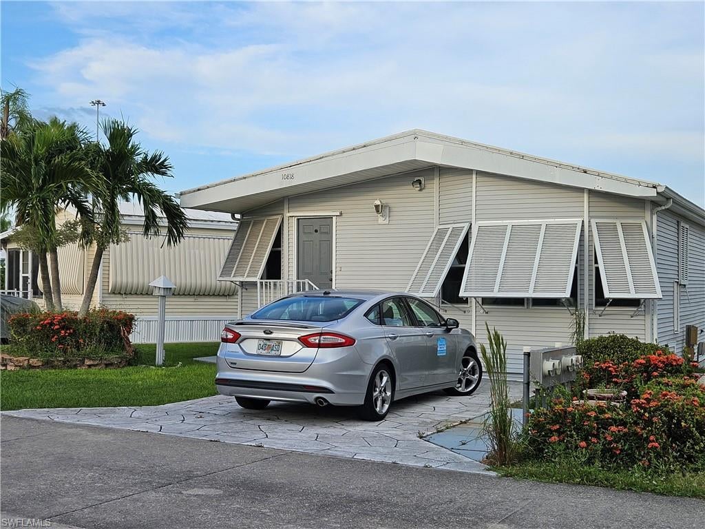 Welcome to the desirable gated community of Corkscrew Woodlands in Estero, known for its natural beauty and peaceful wooded surroundings. This well-maintained 1994 Park Model home sits on a full concrete slab foundation and offers generous storage space underneath the home, perfect for tools, seasonal items, or outdoor equipment. Enjoy the atmosphere of this lake front circle (home has views from across the street) and a short walk to clubhouse and pool. Inside, the home features a convenient laundry-guest room with washer and dryer. The separate laundry room (App.65 sq .ft) with a door, window and a floor register has room for a twin bed. The living room includes a sleeper sofa. All new plumbing 2025. AC and all the ductwork replaced in 2022. TPO Membrane roof 2017. Main Panel 2024.