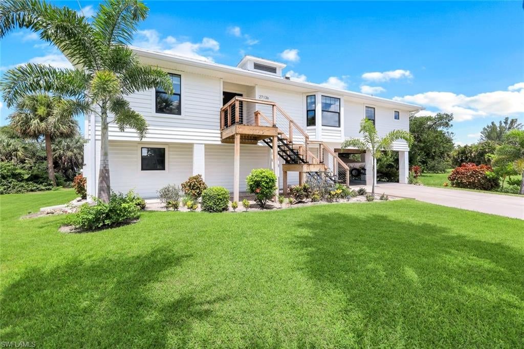 Light & bright, canal-front gulf access home, with recently rebuilt dock (w/ water & electric), has been meticulously cared for. Beautiful wood floors in the main living area and pristine carpet in the bedrooms, new stairs on front and rear of the home.  Kitchen has solid wood custom cabinetry, new quartz countertops as well as a breakfast nook space with bay window. Large master bedroom has custom walk-in closet & frameless shower door in the master ensuite. Enjoy peaceful canal views from either the second level 234 Sq Ft screened-in deck or the first level patio. Pocketing sliding glass doors from both the master bedroom and living room lead out to the screened in deck. The laundry room is a great size and downstairs has a 630 Sq Ft enclosed space for storage and/or a workshop. Located just off of W. Terry St which has wide sidewalks, great for biking or walking to Starbucks and Publix, or the dining & shopping at The Promenade at Bonita Bay. Located across the street from Bonita Fairways and a 5 min drive to the restaurants, coffe shops, and entertainment venues of Downtown Bonita. A wind mitigation was conducted on the reinfornced metal roof in 2023 (ask agent for report), the property has a transferrable flood policy as well as a low interest rate VA loan that can be assumed by qualified veterans. Seller represents that canal can fit boat up to 23'.
