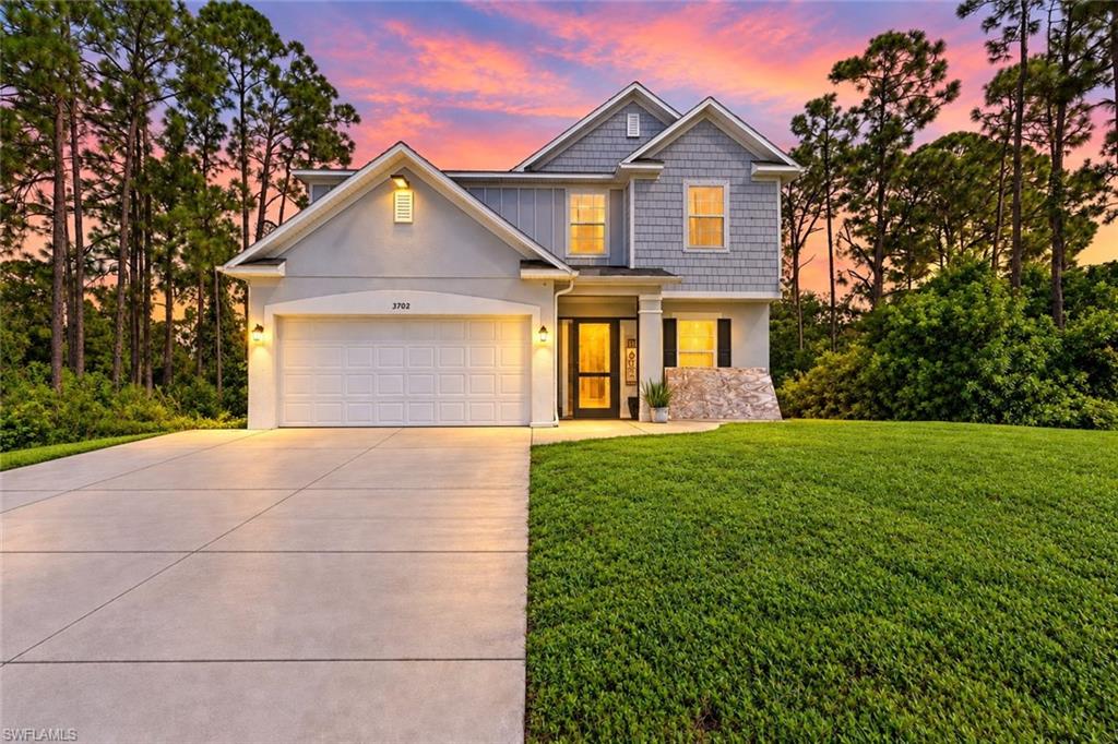Welcome home to this MAGNIFICENT CUSTOM-BUILT HEATED POOL HOME nestled on a quiet dead-end street, with the additional corner lot (3704 3rd St SW) also listed for sale, offering the opportunity to create a HALF-ACRE property with DUAL ROAD ACCESS in the highly desirable SW area of Lehigh Acres! This 3-bedroom, 2.5-bathroom + DEN home spotlights an INTEGRATED RAISED PERIMETER-OVERFLOW SPA, a generously sized COVERED paver deck, LED lighting, and an admirable STACKED STONE WALL WITH WATERFALLS! Come see this open-concept floor plan featuring an enticing illuminated 3D panel accent wall, desirable wood-plank tile throughout the first floor, a welcoming breakfast bar with stunning waterfall quartz countertops and backsplash, a pot filler, top-of-the-line stainless steel appliances with a cooktop range, and glass French double doors leading to the den/office. The second floor highlights a spacious entertainment area, tray ceilings in the oversized master bedroom, a lavish walk-in closet with built-in shelving and glass cabinets, dual sinks in both the guest and master bathrooms, and additional shelving in the master bathroom. This beautifully landscaped property also features built-in surround sound, a screened front entrance, and a mini split A/C unit in the garage. Located in the highly desirable SW area of Lehigh Acres on a quiet dead-end street, just minutes from major amenities and offering a quick commute to Fort Myers. Schedule your showing today!