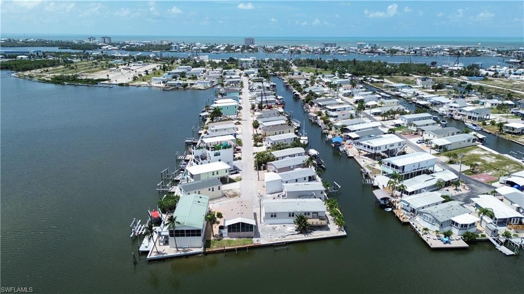 Looking for the perfect waterfront property with unmatched flexibility and value? 36 Emily Lane stands out as San Carlos Island’s crown jewel—and here’s why: It offers direct Gulf access via a deep water canal and is located near the end of the street, allowing you to build your own private boat dock. Not only do you live on a channel, the lower elevation of the homes on either side and across the street creates a rare opportunity to build up and enjoy west-facing views of both the channel and Hurricane Bay. Build with confidence—strategic seawall and foundation upgrades completed in May 2026 feature tieback reinforcement, resin soil stabilization, and improved drainage systems. This proactive investment enhances stability, mitigates erosion risk, and adds lasting value for your future development. With no height restrictions and minimal setback requirements, you have the freedom to design and build the custom coastal home you’ve always dreamed of, with more buildable space, not just for manufactured homes. You own the land outright—no land lease—and it’s the only street in the subdivision with central water and sewer, a rare and valuable upgrade. There are no pet restrictions, both short and long term rentals are allowed, it’s not a 55+ community, and HOA fees are just $55/month! A new patio was installed in 2022 that still looks great! Emily Lane offers better walkability to restaurants, Salty Sam's Marina (with more marinas under construction), and the Key West Express, all right at the start of the street. You can walk over the bridge to the beach without dealing with traffic, and enjoy a more affordable, less congested version of the same coastal lifestyle.