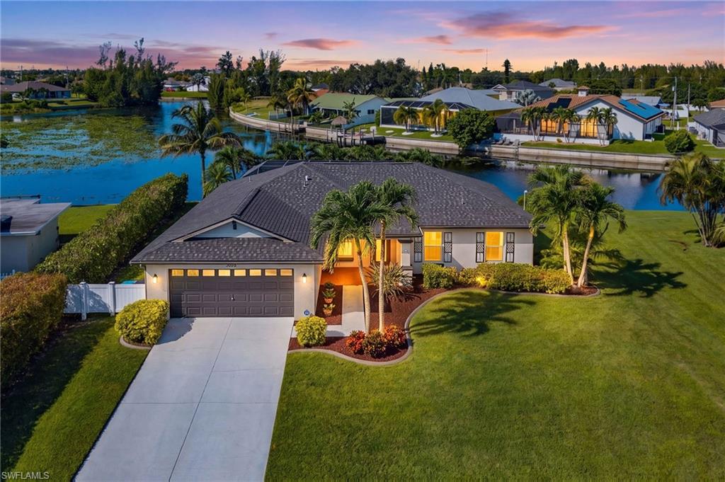 FLOOD ZONE X, CITY ASSESSMENTS PAID, NEW ROOF IN 2022, FRESHWATER WATERFRONT WITH WESTERN EXPOSURE, NEW A/C, NEW WATER HEATER, OVERSIZED LOT AND 99 FT OF SEAWALL! If spectacular sunsets, wide water views and the Florida waterfront lifestyle are on your wish list, this exceptional SW Cape Coral home delivers! Situated on an oversized homesite overlooking a beautiful freshwater basin, this meticulously maintained 3-bedroom PLUS DEN, 2-bath pool home offers 1,666 Sq Ft of thoughtfully designed living space, combining comfort, privacy and an outstanding waterfront setting.

From the moment you arrive, you'll appreciate the lush tropical landscaping, manicured lawn and inviting curb appeal. Inside, the open great-room design features tile flooring throughout, vaulted ceilings, crown molding and attractive architectural details that create a warm yet refined atmosphere. The spacious kitchen features granite countertops, stainless steel appliances, abundant cabinetry and a generous breakfast bar that opens to the main living and dining areas, making it ideal for everyday living and entertaining. A separate den offers additional flexibility for a home office, hobby room or guest space.

Step outside and experience what Southwest Florida living is all about! The expansive screened lanai features a HEATED POOL, generous lounging and entertaining space, and breathtaking views across the wide freshwater basin. With desirable Western exposure, enjoy sunshine throughout the afternoon and spectacular sunsets over the water. The oversized backyard is beautifully landscaped with mature palms and offers an exceptional amount of green space, while approximately 99 feet of seawall enhances the waterfront setting. Whether relaxing poolside, enjoying your morning coffee by the water, kayaking or fishing, this outdoor space is truly something special.

This home has been exceptionally cared for, with valuable updates including a NEW ROOF IN 2022, NEW A/C, NEW WATER HEATER, NEW POOL PUMP and RESCREENED POOL ENCLOSURE. Located in desirable SW Cape Coral with convenient access to shopping, dining, parks and everyday amenities, this property offers the perfect combination of a move-in-ready home, generous outdoor living and a beautiful waterfront location. A wonderful opportunity to enjoy the Southwest Florida lifestyle, where every day feels like a getaway! Schedule your private tour today!