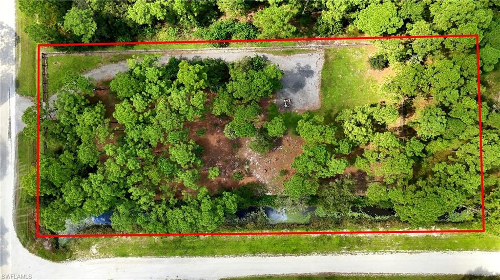 If you’ve been searching for the ideal piece of land that offers privacy, acreage, and freedom THIS IS THE ONE! Perfectly positioned near the entrance of Montura Ranch Estates, this CORNER LOT offers over an acre of opportunity to create the lifestyle you’ve always envisioned. The impressive DRIVEWAY EXTENDS ALL THE WAY TO THE BACK OF THE PROPERTY, providing exceptional accessibility and allowing you to maximize every inch of your acreage. CLEARED leaving selected trees for shade AND FENCED. A canal runs by the property, giving you a natural buffer for privacy. Whether your vision includes a custom-built home, installing a mobile home, or simply a place to enjoy the outdoors with your animals, this property offers the space to turn those possibilities into reality. NO HOA fees/restrictions. ANIMALS WELCOME. SURVEY AVAILABLE. Situated near the entrance of Montura Ranch Estates, you’ll enjoy convenient access without having to travel deep into the community. THE LAND IS CLEARED. THE DRIVEWAY IS IN. THE PROPERTY IS FENCED. ALL THAT’S MISSING IS YOUR VISION! Don’t settle for just another vacant lot when you can own a property that already offers so much more!