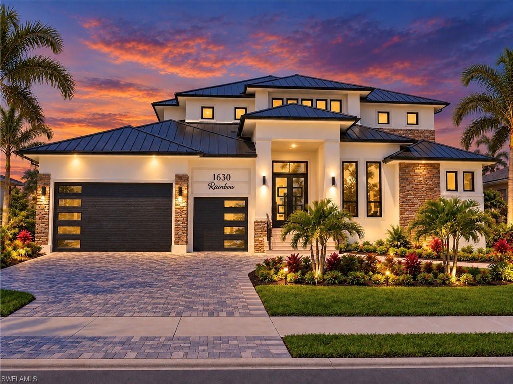 One or more photo(s) has been virtually staged, AI generated or rendered.  Experience refined coastal luxury in this exceptional custom-built five-bedroom-plus-den, four-and-a-half-bath contemporary residence, where sophisticated design, thoughtful craftsmanship, and effortless indoor-outdoor living come together. Encompassing more than 3,400 square feet of air-conditioned living space, this remarkable two-story estate was designed for both elegant entertaining and comfortable everyday living.
From the moment you enter, the home’s sense of tranquility and sophistication is immediately apparent. The inviting living room features a striking custom accent wall and built-in electric fireplace, creating a warm and serene gathering space. Just beyond, the gourmet chef’s kitchen serves as the heart of the home, featuring Taj Mahal granite countertops and backsplash for your culinary preparation—along with custom handcrafted cabinetry and a discreet walk-in pantry that keeps everything effortlessly organized.
The thoughtfully designed floor plan offers exceptional privacy, with a luxurious primary suite retreat and an en-suite guest bedroom conveniently located on the main level. Upstairs, two additional en-suite guest bedrooms provide a private retreat for family and guests, while a spacious laundry room with sink, extensive cabinetry, and generous storage brings function and style to everyday living.
A versatile second-floor loft opens to an expansive covered terrace, creating an exceptional setting for enjoying the Florida lifestyle. The custom wet bar is beautifully appointed with a beverage cooler, sink, custom cabinetry, and floating shelves—perfect for intimate gatherings or entertaining on a grander scale.
Throughout the residence, elegant tile flooring, impact-rated windows and doors, and carefully selected finishes reflect the home’s commitment to quality and enduring style.
The outdoor living experience is equally impressive. Designed as a private resort-style retreat, the expansive outdoor space features a sparkling saltwater pool and spa, summer kitchen with bar, beverage cooler and ice machine, and an outdoor shower. Whether enjoying a quiet afternoon by the pool or hosting an evening gathering beneath the Florida sky, this exceptional outdoor environment is designed for effortless entertaining and year-round enjoyment.
A generous three-and-a-half-car garage provides abundant storage and parking, while an oversized garage door accommodates a small RV or recreational vehicle.
Every element of this extraordinary Marco Island residence has been thoughtfully considered—from the sophisticated architectural design and exceptional entertaining spaces to the seamless connection between indoor and outdoor living. This is more than a luxury home; it is a private retreat crafted for those who appreciate exceptional quality, elevated comfort, and the distinctive Florida lifestyle.