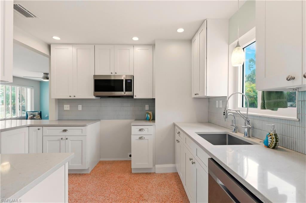 his home is the quintessential mid-century Florida ranch with a beachy flair. It sits on an oversized lot with beautiful landscaping and mature trees. The paver driveway and porch make a welcoming statement. Stepping inside you’ll find a spacious living room and dining room with plenty of room for entertaining. The kitchen has been remodeled for a more open work space including a peninsula for stools and an adjacent lit bar. Beautiful quartz countertops in the kitchen as well as all bathrooms. To the left you’ll find three spacious bedrooms with plenty of closet space. They easily accommodate a king and two queen beds. The hall bath features a walk-in shower with glass tiles. One of the bedrooms also features a separate half bath. Throughout the house are the gorgeous original polished terrazzo floors in a very unique color. Step past the kitchen into the sunroom with its additional pantry space. Enjoy the beautiful view of the back yard through the large triple glass sliders. The sun room helps to create the popular split floor plan with the primary bedroom. The large primary features an on-suite bath and large walk-in closet. Off the sun room you’ll also find the one car garage with washer and dryer hookups. The backyard is your own mini resort to feel like you’re always on vacation. The large backyard features a pool and tiki hut for amazing entertaining. The tiki is wired with lights and ceiling fan. Don’t miss the private hot and cold outdoor shower. Great mid island location. Publix, Snook Bight Marina, Junkanoo, and Fresh Catch Bistro are just around the corner. Enjoy direct access to the beach on a deeded easement. The metal roof is approximately 12 years old. Furnace, AC, and tankless water heater installed 2022. Completely rewired in 2022.