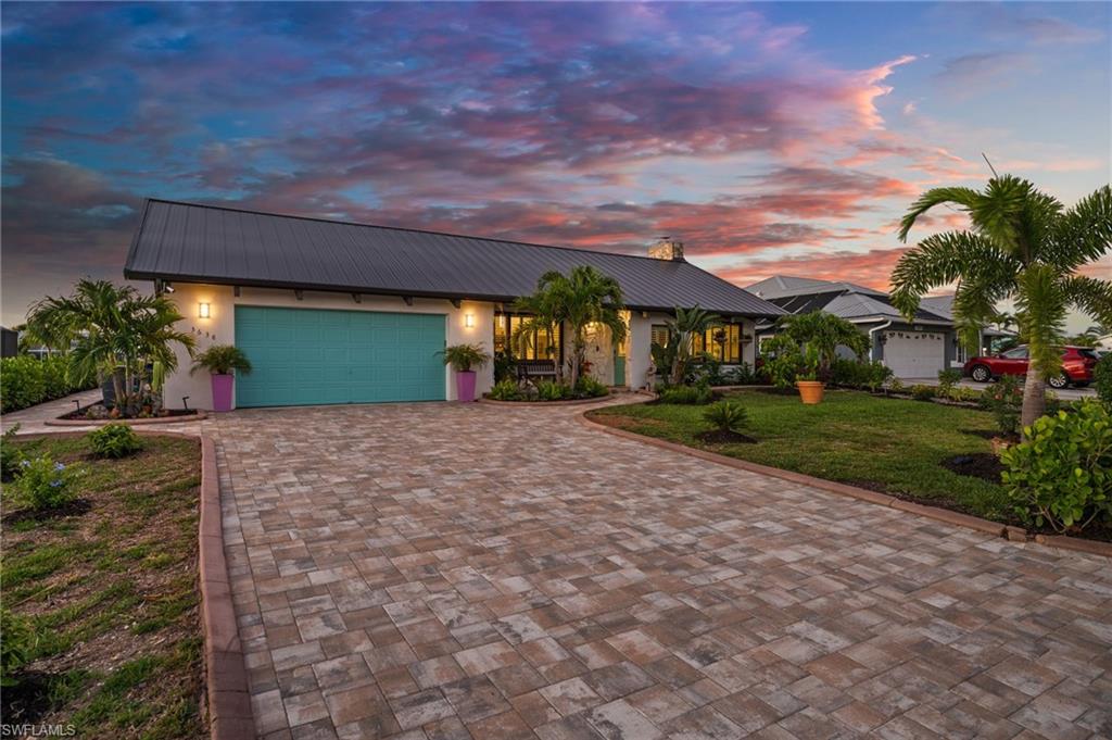 TIMELESS DESIGN MEETS ISLAND LIVING AT ITS FINEST! Prepare to be impressed—this one-of-a-kind, masterfully remodeled residence is anything but ordinary. From the moment you arrive, the attention to detail is undeniable, blending refined craftsmanship with relaxed coastal sophistication. An extended paver driveway, lush tropical landscaping, and a striking bronze standing seam metal roof set the tone for what awaits inside. Step through the front door into an expansive great room where soaring vaulted ceilings, custom millwork, and coastal shiplap accents create a bright, airy space designed to impress. Every element has been thoughtfully curated, delivering a seamless blend of contemporary coastal style with warm, inviting textures throughout. The heart of the home is a show-stopping kitchen, featuring a large center island with thick-cut granite, crisp white shaker cabinetry, stainless steel appliances, a farmhouse sink, and a built-in bar/entertaining station—perfect for gathering with family and friends. Storage is abundant, highlighted by an entire wall of custom cabinetry that adds both beauty and function. Indoor and outdoor living come together effortlessly with quadruple disappearing sliders that open to your private courtyard oasis. Here, you’ll find a spacious pool and spa, picture window screening for unobstructed views, and generous space for lounging, dining, and entertaining year-round.
The primary suite is a true retreat—oversized and serene—with direct access to the pool area, a spa-inspired bathroom featuring dual vanities, multiple showerheads, and a bidet, along with an impressive European-style walk-in closet spanning approximately 16 feet. Two additional guest bedrooms and baths are thoughtfully positioned on the opposite side of the home, offering privacy and convenient pool access, with one room featuring a built-in Murphy bed for flexibility. Out back, the waterfront lifestyle takes center stage. Situated on the Manatee Canal, this property is fully equipped for boating enthusiasts with two 10,000 lb covered lifts, an expansive captain’s walk spanning the width of the property, and a charming tiki hut creating the ultimate outdoor gathering space. With quick, direct access to open water, you’re just minutes from the Gulf of Mexico, world-class fishing, and the stunning barrier islands - while an additional 25' x 80' parcel across the street provides bonus storage for boats, RVs, or extra toys. Whether you’re searching for a full-time residence, seasonal escape, or investment opportunity, this exceptional property delivers the very best of St. James City living—where every day feels like a vacation.