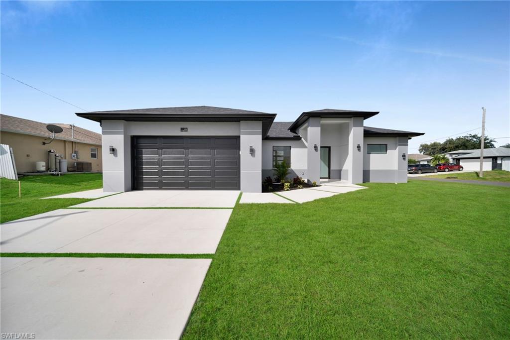 CITY WATER AND NO FLOOD ZONE! Discover this brand-new, move-in-ready home situated on a corner lot and complete with a builder’s warranty. Thoughtfully designed with porcelain tile throughout, this home offers a beautiful blend of comfort and style.
The primary suite features a gorgeous bathroom with a spa-like tub, creating the perfect place to unwind at the end of the day. Custom closets throughout the home provide additional storage and a polished touch.

Enjoy the Florida lifestyle with an outdoor kitchen, ideal for preparing meals and entertaining. Additional features include impact-resistant windows and doors and laundry in residence. With its modern finishes and inviting spaces, this home is ready for you to move in and make it your own.