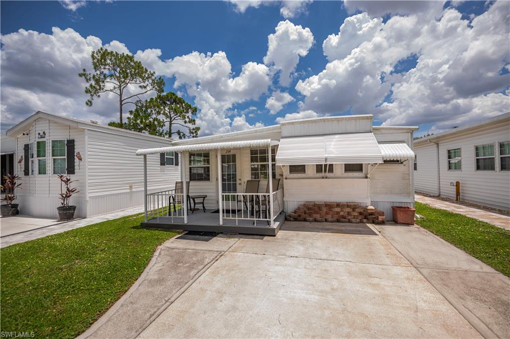 Located in the desirable Fountain View RV Resort, a well-established 55+ community where you own the land, this beautifully maintained turnkey-furnished 1-bedroom, 1.5-bath home offers approximately 748 square feet of comfortable living space. Designed for easy Florida living, the home features a spacious kitchen with abundant built-in cabinetry, an inviting living area, convenient in-residence laundry, and a functional floor plan that makes excellent use of space.  Enjoy peaceful outdoor living from the covered front porch overlooking open green space and mature trees, providing a relaxing setting to enjoy your morning coffee or evening breeze. The perimeter location offers added privacy with a small yard and fenced area, while clamshell awning shutters provide shade and storm protection. A new front awning installed in 2026 enhances both curb appeal and outdoor comfort. Residents of Fountain View RV Resort enjoy an active lifestyle with an impressive selection of amenities, including a clubhouse, community pool and spa, bocce, shuffleboard, tennis, volleyball, basketball, and optional RV and boat storage. The low HOA fee of $264.50 per month includes cable, community laundry facilities, lawn/land maintenance, on-site management, and use of the community’s recreational facilities, reserve, sewer, street lights, street maintenance, trash and water. Conveniently located just minutes from downtown Fort Myers, shopping, dining, medical facilities, golf courses, and Southwest Florida's beautiful beaches, this move-in-ready home offers an outstanding opportunity to enjoy affordable, maintenance-free Florida living.