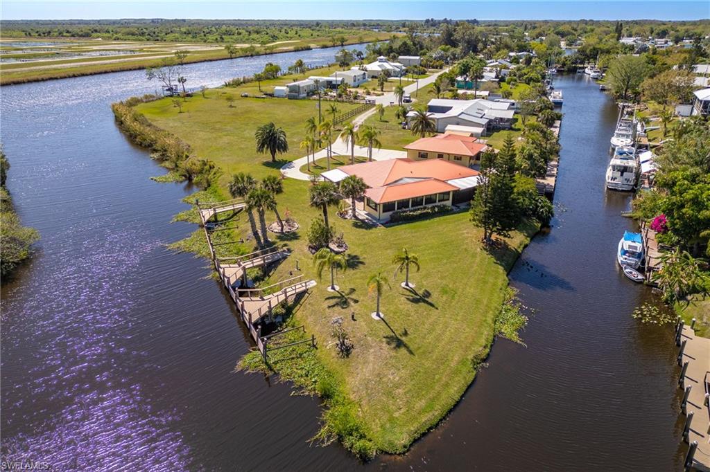 ACCEPTING BACK UP OFFERS! LOCATION, LOCATION, LOCATION! Boaters, this is as good as it gets! Situated on a peninsula with protected deep water on two sides and FOUR private docks, this property is a rare gem. The Intracoastal (Caloosahatchee River) in this area is shielded by locks—offering protection from tides and storm surge—while still providing deep-water access to the Gulf of Mexico, the Atlantic Ocean, and Lake Okeechobee.

The spacious home showcases incredible water views, impact windows, a newer metal roof, and a relaxing hot tub on the screened lanai. Enjoy the Florida lifestyle from the screened front and back porches, or spread out in the open floor plan featuring a huge Florida room. Additional highlights include a garage/workshop, a detached guest house, a large carport ideal for boat or RV storage, a storage shed, and even a kayak/canoe launch.

This property also offers excellent income potential—rent one or more docks, use the guest house as an Airbnb or seasonal rental, or simply host friends and family.

Opportunities like this are rare—don’t let this waterfront treasure slip away!