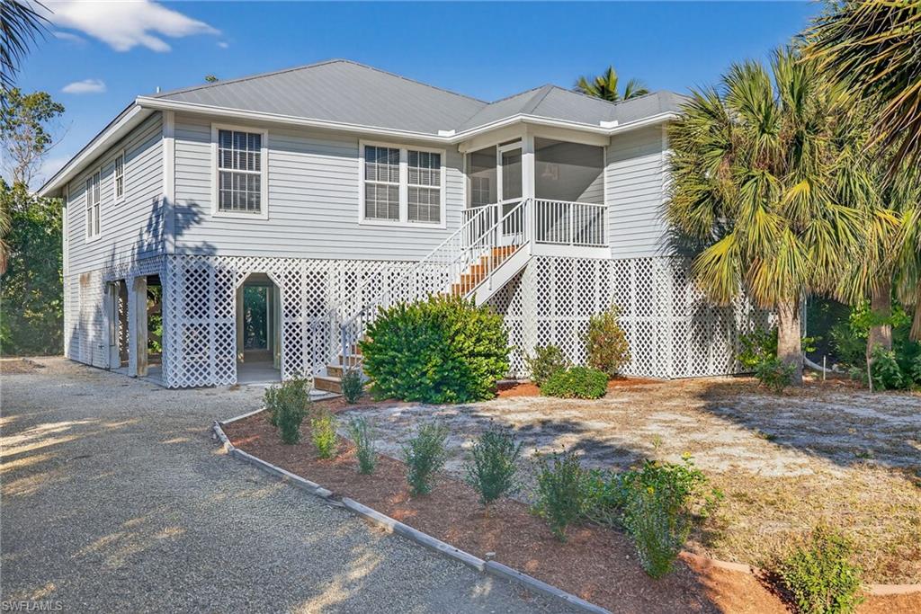 Enjoy relaxed waterfront living in this elevated canal home on Sanibel’s desirable east end. Offering three bedrooms and two baths, with one bedroom currently used as an office, the home combines bright, open living spaces with inviting outdoor areas and everyday conveniences. Offered partially furnished, it provides a comfortable start to making island life your own.

A screened front porch welcomes you inside, where vaulted ceilings and abundant natural light give the living and dining areas an airy, spacious feel. The open layout connects seamlessly to a kitchen featuring white cabinetry, granite countertops, stainless steel appliances, and a breakfast bar that keeps the cook connected to family and guests. A separate laundry room adds practical convenience.

Sliding glass doors extend the living space onto a generous screened rear porch overlooking the canal and tropical vegetation. With room for dining and lounging, this peaceful setting is ideal for morning coffee, casual meals, and evenings spent enjoying colorful skies with western rear exposure.

The spacious primary suite features direct access to the rear porch, two closets, and an en suite bath with a separate soaking tub and walk-in shower. The guest bedroom and second bath are positioned toward the front of the home, while the office provides flexible space for working from home or accommodating visitors.

A private dock brings the waterfront setting to life, offering a place to enjoy the canal and surrounding nature. Below the home, covered parking and generous storage accommodate bikes, beach gear, and island essentials, while a private elevator provides convenient access to the main living level.

From its welcoming porches to its bright interior and quiet canal setting, this east-end home offers a comfortable place to settle into Sanibel’s easygoing waterfront lifestyle.