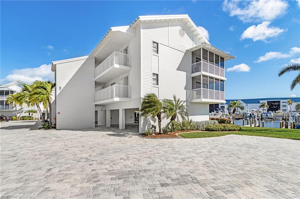 Experience effortless coastal living in this modern and sleek 2-bedroom, 2-bath turnkey penthouse end-unit condo, ideally located in the highly desirable Four Winds Marina community. Soaring vaulted ceilings enhance the open, light-filled layout, while impact-resistant doors and windows provide peace of mind. Enjoy tile and luxury vinyl plank flooring throughout, complemented by beautifully designed, contemporary kitchens and bathrooms. The spacious wraparound screened lanai offers coveted southeast exposure—perfect for relaxing in afternoon shade while still capturing glimpses of stunning sunsets and shimmering water reflections. Just steps away, you’ll find the popular Lazy Flamingo restaurant and world-class fishing charters. Also located a short distance away is Jug Creek Marina & Fish House, where you can enjoy more tasty island food and cath the ferry for amazing tours and adventures. Surrounded by abundant wildlife including dolphins, manatees, wild birds, and schools of fish, this prime waterfront location provides quick boating access to Sanibel, Pine Island, Captiva, Boca Grande, Cayo Costa, and beyond. The solid, secure building features concrete pillars and walls, a durable metal roof installed in 2022, and is complemented by a beautifully updated community with new brick paver driveways, ample parking, and fresh landscaping throughout. Schedule your private showing today and start living the waterfront lifestyle you’ve been dreaming of.
