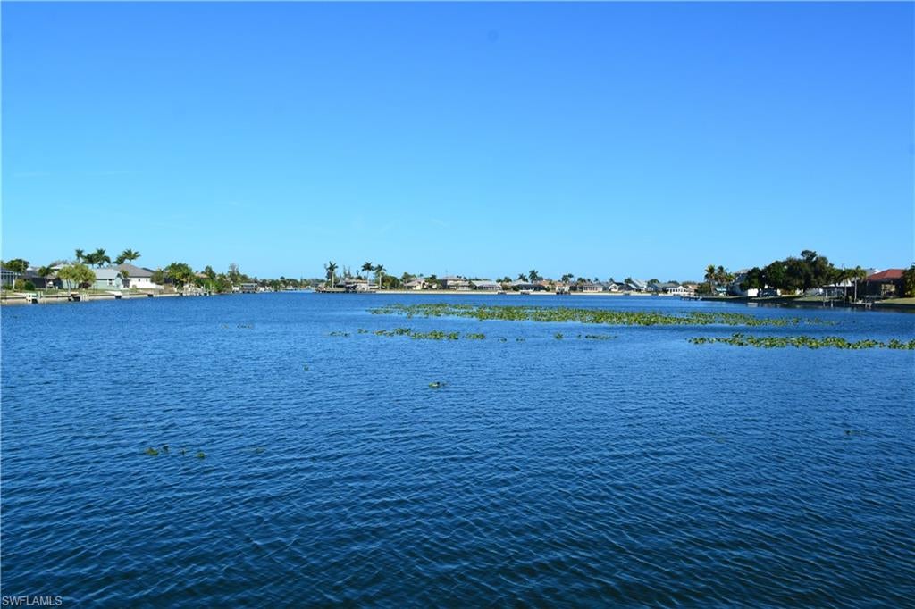 Welcome to an exceptional opportunity to build your custom dream home on the highly desirable South Shore of Lake Alhambra. This premier waterfront homesite offers breathtaking panoramic lake views and direct access to miles of navigable waterways, placing you at the heart of Cape Coral’s renowned chain-of-lakes system.

From your backyard, set sail through interconnected waterways that lead to Lake Kennedy, Lake Saratoga, Shamrock Lake, and numerous other lakes—perfect for boating, kayaking, fishing, and sunset cruises. Whether you’re an avid boater or simply enjoy tranquil waterfront living, this location delivers the ideal balance of recreation and relaxation.

Nature lovers will appreciate the daily wildlife encounters, from osprey diving for fish to playful otters and graceful turtles gliding through the water, creating a serene and picturesque setting right outside your door.

Adding to the value, all assessments are fully paid, offering peace of mind and simplifying the path to construction. Ideally situated, this property provides quick access to Cape Coral’s top dining, shopping, entertainment, and outdoor recreation, while still maintaining a quiet, residential feel.

Opportunities like this are rare—secure your place on one of Cape Coral’s most sought-after lakefront locations and start envisioning the waterfront lifestyle you’ve been dreaming of. Don’t wait—this one won’t last.