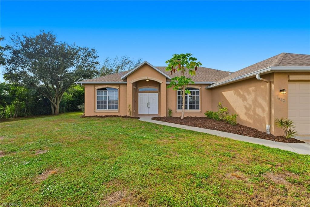 Charming single-level home featuring 4 bedrooms, 2 bathrooms, and a 2-car garage. The inviting living room showcases a cozy fireplace and accent lighting visible from the dining area and kitchen. The kitchen offers a decorative backsplash, stainless steel appliances, and a pantry. Enjoy a spacious primary suite with a double vanity and a relaxing retreat outdoors with a screened lanai, private pool, and spa. A double-door front entry adds elegance and curb appeal.