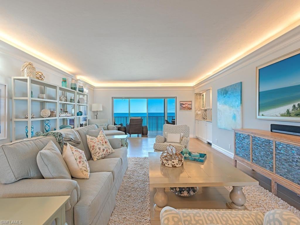 Enjoy sweeping Gulf views and gentle coastal breezes from this beautifully appointed top floor residence at Westgate in The Moorings. Offering three bedrooms, three bathrooms, and 2,805 square feet of living space, this inviting coastal retreat combines generous proportions with custom finishes throughout. The spacious great room provides a welcoming setting for everyday living and entertaining, framed by views of the Gulf and spectacular sunsets. A formal dining room, an open-air covered balcony, and a newly updated kitchen with high-end appliances further enhance the residence’s appeal. The primary suite features two walk-in closets and a well-appointed bath with dual sinks and a spacious walk-in shower, while both guest bedrooms offer comfortable accommodations and en-suite bathrooms. Additional features include impact-resistant windows, electric hurricane shutters, window treatments, a deeded covered parking space, and private storage. With just 48 residences and a beautifully remodeled lobby, Westgate offers an intimate beachfront setting complemented by a saltwater pool, sunset terrace, poolside social room, fitness center, bike and kayak storage, outdoor barbecue area, car wash, and professional on-site management. Direct beach access and proximity to the waterfront boutiques and restaurants of Venetian Village complete this exceptional Naples coastal lifestyle.