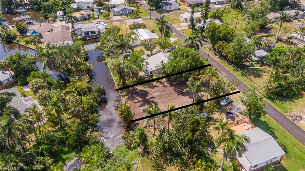 Affordable waterfront land near Downtown Fort Myers! Build your Southwest Florida home on this cleared canal-front lot in North Fort Myers, just across the Caloosahatchee River from Downtown Fort Myers and the historic River District. Located at the end of a canal with Gulf access, this 60' x 150' residential homesite offers a hard-to-find opportunity to enjoy the Florida boating lifestyle at an approachable price. Enjoy proximity to the Caloosahatchee River, Downtown Fort Myers, Marinatown, waterfront dining, boating, live music, and entertainment, with exciting growth and redevelopment continuing along the Fort Myers waterfront. The River District and areas surrounding Legacy Harbour, Legacy Island and Lofton Island are just across the river, while home is tucked into a quiet North Fort Myers neighborhood known for its charming roaming peacocks. With no HOA, approximately 9,017 square feet, and a cleared homesite ready for your vision, this is your chance to build near the water and close to the action. Bring your builder, your boat, and your Florida dream! Whether you're searching for waterfront land in North Fort Myers, a Gulf-access lot, vacant land near Downtown Fort Myers, or an affordable Southwest Florida homesite, 67 Oak Street puts you close to the water, boating, and everything happening along the Fort Myers riverfront.