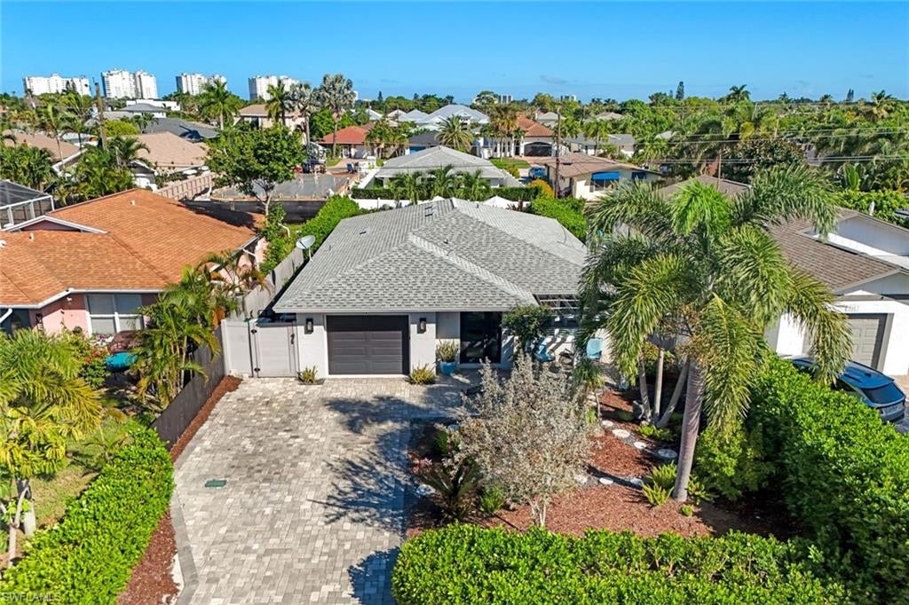 Beautifully reimagined and offered turnkey, this stylish and well-appointed Naples Park home has been completely updated with fresh, thoughtfully selected finishes throughout. Polished yet wonderfully relaxed and welcoming, every space feels considered and inviting.

A gardener’s touch can be felt throughout the property, where lush landscaping and thoughtfully designed outdoor spaces create a serene, private setting. Just off the kitchen, a charming courtyard-style sitting area provides an intimate spot for morning coffee, alfresco dining or a quiet evening surrounded by greenery.

The fabulous outdoor living area is the heart of the home. Bedrooms open directly to the pool area, creating a seamless connection between indoor and outdoor living. A sparkling pool and hot tub, built in 2020, are complemented by a pergola-covered bar and inviting spaces to lounge, gather, and entertain, an idyllic setting for enjoying the Naples lifestyle year round.

The location is hard to beat. Ideally positioned in Naples Park near Vanderbilt Beach, Delnor-Wiggins Pass State Park, Mercato and some of Naples’ best dining and shopping, the home puts the best of North Naples within easy reach. Situated in the desirable X500 flood zone with no HOA, this turnkey property offers a rare combination of style, serenity, location and effortless Florida living.