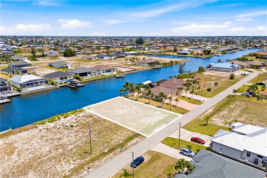 Direct Sailboat Gulf Access with no bridges, a seawall already in place, and an extra-wide canal setting! This exceptional waterfront lot offers a rare opportunity to build your dream residence in one of Northwest Cape Coral’s rapidly growing and highly desirable boating corridors.
Positioned along the expansive Salida Canal, measuring approximately 180 feet across, this property captures beautiful open water views and provides an impressive backdrop for luxury waterfront living. Located west of Burnt Store Road and south of Gulfstream Boulevard, the lot offers convenient access toward the Spreader Canal, Matlacha Pass, and the Gulf. Design a custom estate that fully embraces the Southwest Florida lifestyle, with room to create an elegant outdoor living space, private dock, and the waterfront retreat you have always envisioned. Enjoy proximity to Pine Island Road shopping and dining, Coral Oaks Golf Course, marinas, nearby parks, Punta Gorda, and the exciting upcoming Seven Islands development. A premier opportunity for boaters, investors, or buyers seeking an exclusive slice of tropical paradise in Cape Coral.