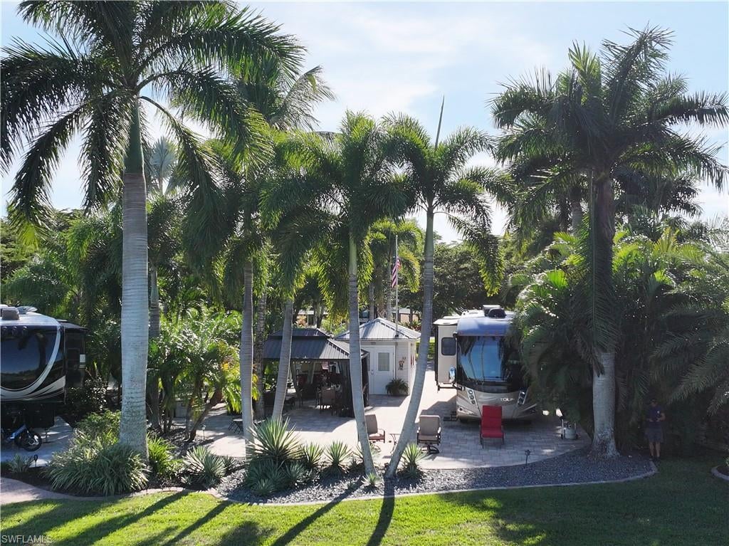 Now available – Lot D32 in Cypress Woods RV Resort, Fort Myers, FL! This exceptional lakefront, oversized pie-shaped lot spans nearly 6,000 sq ft, making it one of the largest and most desirable lots in the community. Beautifully improved with full paver coverage, rock landscaping, and mature palm and coconut trees, the lot offers a serene, tropical setting with no neighbors directly across, enhancing privacy and views. The finished accessory building includes a toilet, shower, and washer/dryer, providing added comfort and convenience. Canopy extensions offer additional shaded outdoor living space — perfect for relaxing or entertaining. Cypress Woods RV Resort is a gated, RV community with resort-style amenities.Open to fifth wheels, class A, and class C. HOA dues are $1,087 per quarter, covering water, sewer, cable, lawn maintenance, internet, and access to all amenities.