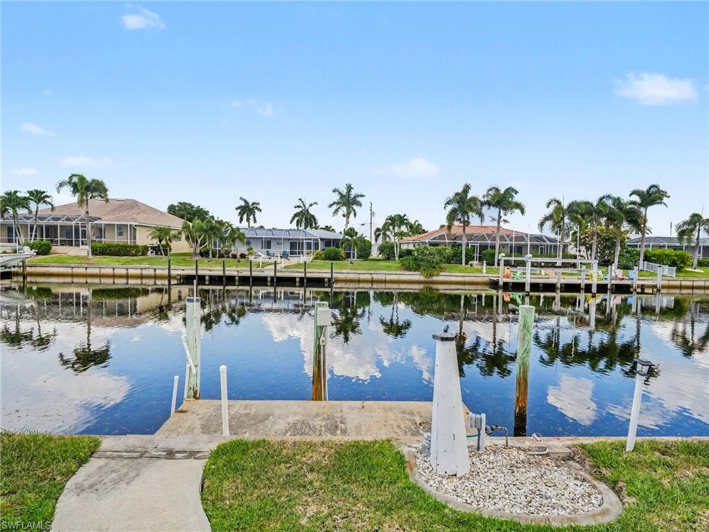 BOATERS—THIS IS THE PUNTA GORDA ISLES LOCATION YOU’VE BEEN WAITING FOR! Enjoy 6–8 minutes of boating access to Charlotte Harbor from this beautifully updated 3-bedroom, 2.5-bath waterfront pool home in sought-after Punta Gorda Isles (PGI). With 80 feet of city-maintained concrete seawall, this home delivers the quick-water-access lifestyle that makes PGI so desirable. Inside, the redesigned open floor plan feels bright, spacious and modern. Improvements include smooth Level 5 drywall finishes, continuous light tile flooring, recessed LED lighting, updated electrical fixtures, new interior doors and trim, remote-controlled ceiling fans and fresh interior paint. The remodeled kitchen is positioned at the center of the home and opens to both main living areas, making it ideal for everyday living and entertaining. Features include real wood soft-close cabinetry, high-end quartz countertops, a large breakfast bar and upgraded KitchenAid appliances, including a downdraft range and built-in drawer microwave. An adjoining family room features a custom built-in bar with cabinetry, quartz countertops, tile backsplash, under-cabinet lighting, sink and dual-compartment wine and beverage refrigerator. This flexible space is perfect for entertaining, watching the game or relaxing after a day on the water. The split-bedroom floor plan provides privacy for owners and guests. The primary suite is located on one side of the home, with two guest bedrooms on the opposite side. Both full bathrooms have been completely remodeled with quartz-topped vanities, soft-close cabinetry, updated plumbing fixtures, LED mirrors and attractive coastal-inspired tile. Outdoor living is one of the home’s defining features. A screened courtyard-style front patio creates a private place for morning coffee or evening conversation. In back, the spacious screened lanai functions as an outdoor living and dining area overlooking the open-air pool, canal and surrounding waterfront homes. New PGT hurricane-impact sliding glass doors provide an easy transition from the interior to the lanai, while M/I hurricane-impact windows with energy-efficient glass are installed throughout the home. The refreshed pool area includes new tile, coping, pool-deck pavers and an LED pool light. The fenced backyard includes spring-loaded gates with child-safety latches. The oversized 2-car garage provides plenty of room for vehicles, bikes, workshop, boating gear and storage. Located on a quiet cul-de-sac just minutes from Fishermen’s Village, downtown Punta Gorda, restaurants, shopping and waterfront parks. If quick boating access, a pool and an updated home are at the top of your list, 548 Belvedere Ct deserves a closer look. See the attached Home Highlights sheet for a complete list of renovations and improvements.
