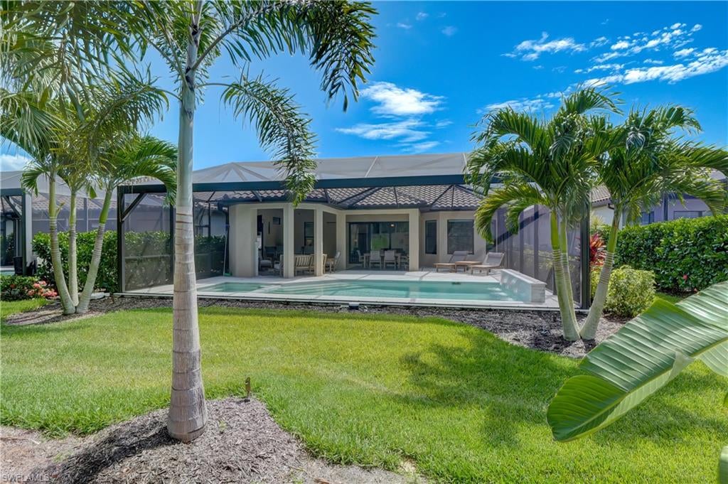 Located near Coconut Point mall and the Ft Myer’s Airport this exceptionally upgraded 3 bedroom+den, 3.5 bath, 2 car garage with gas heated saltwater pool & spa, is located in the Pebble Pointe at the Brooks community.  The home is highlighted by its large lanai, with a picture view screen at the back.  Beautiful travertine pavers surround a gorgeous contemporary pool and spa.  A gas fireplace, summer kitchen with built-in gas grill and bar-top, a large dining and leisure area complete the beautiful indoor/outdoor Florida living area. Easy entertaining inside with open concept living, a large great room, and an eat-in-kitchen with breakfast bar. The gourmet kitchen features a gas cooktop, center island, stainless steel appliances, and Cambria quartz countertops.  Laminate wood flooring throughout the main living areas offers great style and easy maintenance.  A large primary suite with walk in closet and custom tiled shower.  Each bedroom has a dedicated ensuite bathroom giving visiting guests a resort style experience. Pebble Pointe at the Brooks is a gated, natural gas community, no CDD, lower HOA fees, dog park, dedicated traffic signal for entrance & exit and a great location!