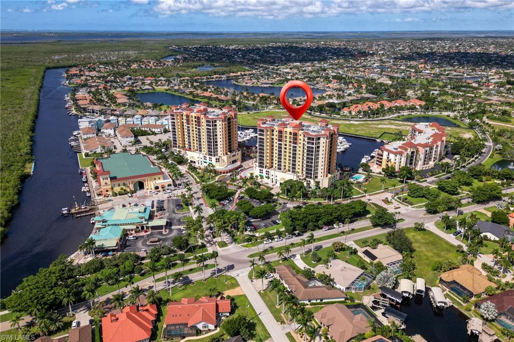 Discover the exceptional Florida waterfront lifestyle, offered turn key, at Cape Harbour, an upscale condominium and boating community offering breathtaking views and an array of resort-style amenities. Enjoy waterfront dining and shopping just downstairs from your home at the community's restaurants, a coffee and ice cream shop, outdoor bars with live entertainment, boutique shopping, and art galleries. Additional amenities include a heated swimming pool, fitness center, tennis and basketball courts, and convenient on-site boat rentals.

This spacious, beautifully furnished 3-bedroom, 2-bath residence features a well-appointed gourmet kitchen with rich wood cabinetry, stainless steel appliances, and granite countertops, along with tile flooring throughout the main living areas. A distinctive feature of this floor plan is its two separate private patios, offering exceptional outdoor living spaces to enjoy Southwest Florida’s spectacular sunrises and vibrant sunset skies.