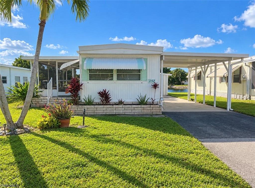 One or more photo(s) has been virtually staged, AI generated or rendered.  Welcome to your Naples getaway in the desirable 55+ community of Cape Sable Lakes! This beautifully maintained 2-bedroom, 1-bath home is being sold fully furnished and features numerous recent updates, making it truly move-in ready! Enjoy a newly remodeled kitchen complete with an added butcher block, a beautifully updated bathroom, and new laminate wood flooring in both bedrooms with new subflooring.

Step outside to your screened lanai and take in the peaceful lake views and spectacular Southwest Florida sunsets. The newly added sun deck provides the perfect spot to soak up the Florida sunshine, relax with your morning coffee, or unwind while enjoying the beautiful outdoor surroundings. The spacious yard and two generously sized storage sheds offer plenty of room for outdoor enjoyment and additional storage.

Best of all, you OWN the land with NO land lease fees! Enjoy the benefits of LOW monthly HOA fees that include cable, internet, lawn care, and land maintenance, making this an affordable and low-maintenance Florida retreat! Cape Sable Lakes also offers wonderful community amenities, including two swimming pools, cabana, and clubhouse. This pet-friendly community allows up to two domestic animals, and only one owner is required to be 55 or older.

Whether you’re searching for a seasonal retreat, a year-round residence, or an investment opportunity, this charming Naples home offers exceptional value, beautiful views, and an inviting Florida lifestyle. Conveniently located near shopping, dining, and Naples’ beautiful beaches, this is an opportunity you won’t want to miss!