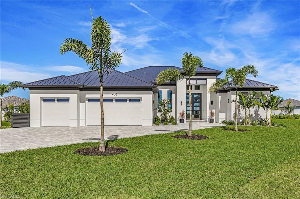 Proudly introducing the LARGEST GULF ACCESS site in Cape Coral!! This Estate style NEW CONSTRUCTION home sits on .62 of an acre!  A Custom (in every way) Masterpiece that redefines what Luxury Waterfront living is all about.  With 3,500 sq ft of meticulously crafted space, this 4bed + Den / 4.5 bath home offers unparalleled Style & Comfort!  As you make your way to the 16’ raised entry and step inside the double 10’ Custom rod iron doors, you’re greeted by a litany of upgraded “convenience” features.  Some include but not limited to:  High end LTV staggered Coastal flooring, Custom Lighting and Fixtures that were tastefully chosen to compliment the overall theme of the home.. Level 4 quartz in kitchen and entertainment bar, soaring tray & coffered ceilings, exceptional craftmanship visible throughout, Chef’s kitchen equipped with high end appliances, including an induction cooktop, double oven, cabinet microwave, Pot filler, sleek dove tail soft close cabinetry, Butler’s pantry and a full house R/O system. The laundry room comes complete with Washer/Dryer, plenty of cabinets/counter top space and a second full sized refrigerator for overflow.  The primary suite is a true retreat & extremely spacious, featuring a walk-through shower with dual heads, 6’ Jetted soaking tub, elegant dual vanities with touch screen mirrors. The second suite is equally impressive, offering ample space and comfort for guests or family. Both suites boast large walk-in closets with custom built-ins. And perhaps their best feature is that both have stunning water views of Prayer Lake! If Outdoor living is your thing- look no further!  This property offers 3 levels of outdoor entertaining space!! With the pool deck having its own putting green! You’ll never feel the squeeze on space by having 817 sq ft of covered lanai, 2,100 sq ft of pool deck & over 1,000 sq ft between the second and bottom level of the landing! You’ll also enjoy having a 14,000 lb boat lift with an Oversized Captains walk, Jet Ski launch, Tiki Hut with round table, Fish carving station and fully automated lights controlled right from your phone.  The OVERSIZED 27X21 Pool/Hot Tub includes a waterfall feature, bubbler on 8ft sun-shelf, 2 LED lights, full automation to operate pool features remotely, and a unique Black tile finish that looks great & rarely seen! Fully equipped outdoor kitchen with high end appliances, ice maker, hood for grill & speakers recessed in the ceiling. **Full list of specs along with “Smart features” are shown in supplemental pages** This home has been thoughtfully equipped with professionally installed "Smart Home" Security, comfort & entertainment technology designed to enhance everyday living while remaining simple and intuitive to use! Boating enthusiasts will delight in the easy access to Sanibel Island, Charlotte Harbor, and the surrounding Islands of Cayo Costa, Boca Grand & Cabbage Key, among many others! All Mechanical and Builder Warranties will convey at sale.