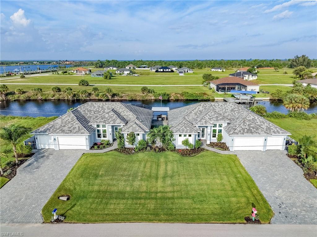 RARE WATERFRONT OPPORTUNITY — TWO HOMES, ONE EXTRAORDINARY ESTATE! Two nearly identical luxury residences offered together as one Gulf-access waterfront estate. Built in 2022 on adjoining lots totaling approximately 0.46 acres, the homes offer a combined 4,884 square feet of living area, four bedrooms with private ensuite baths, six bathrooms, two offices with built-in desks, two flex rooms with lanai access, and six garage spaces. Ideal for multigenerational living, extended family, or guests seeking privacy.

Both homes feature custom closet built-ins, impact windows and sliders, powered shutters at lanais and front entrances, upgraded tile, designer lighting, extended pantries, Wi-Fi-enabled Bosch appliances, custom kitchen islands with pull-out storage, and Kasa smart switches. Residence 3802 also features an integrated Bosch barista system, an enlarged office and generator direct-connect capability.

Technology includes hardwired alarm systems, ADT security, and Google cameras for remote monitoring. Each climate-controlled garage has dedicated air conditioning, foam insulation, and Tesla charging. Additional upgrades include Kinetico whole-house water systems with 500-gallon storage tanks, instant hot water, and whole-house electrical grounding.

OUTDOOR LIVING AND BOATING TAKE CENTER STAGE! Residence 3802 features a remotely controlled Pentair pool and spa, private dock, covered 13,000-pound boat lift, and captain's walk. Residence 3806 offers an extended lanai. Between the homes, a covered outdoor kitchen features a four-burner grill, refrigerator, prep area, and Big Green Egg, complemented by a lower-level sitting and entertaining area.

The fenced estate features concrete-reinforced posts and iron canal fencing preserving waterfront views. Gulf access includes just one 9-foot-clearance bridge to open water. Both homes feature enhanced roof strapping, foam insulation extending into the garages, and elevated construction to meet VA-related requirements. Per sellers, neither home has experienced flooding.

Offered furnished, subject to inventory and exclusions. Offered together for $2,998,000. See companion listing MLS #2026041183. Both properties must be purchased together.