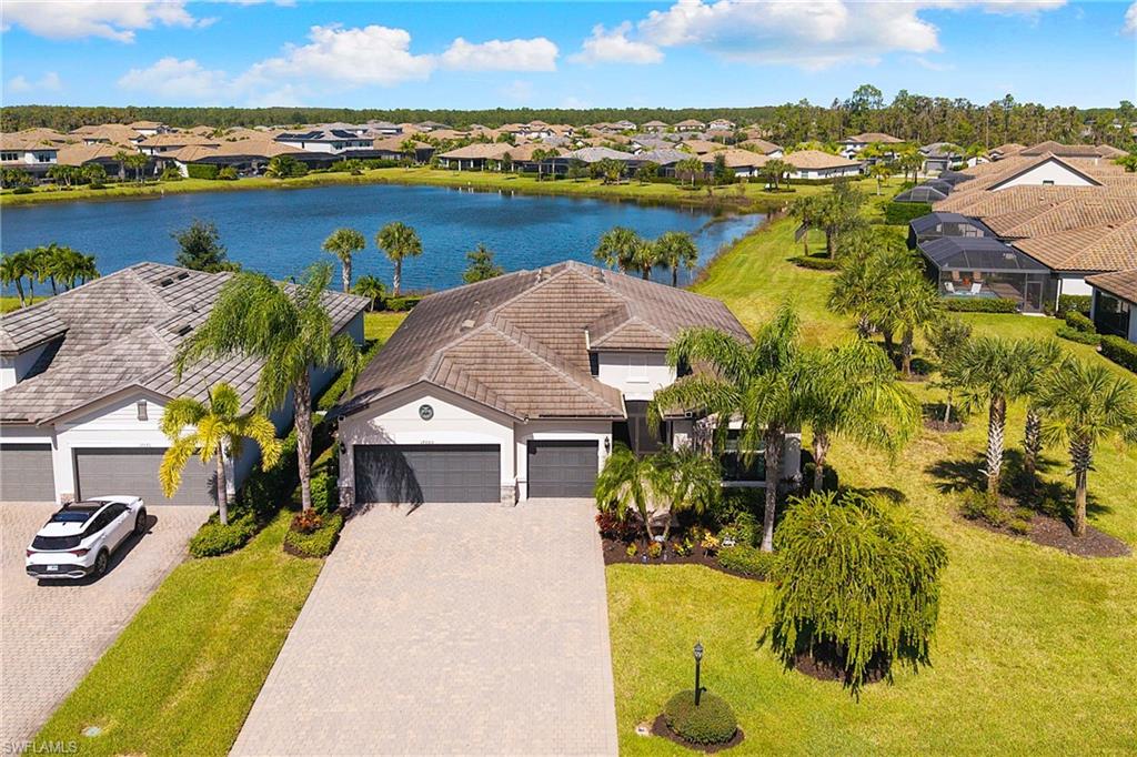 HIGHLY SOUGHT AFTER "SUMMERVILLE" HOME LOCATED ON A QUIET CUL-DE-SAC STREET WITH GORGEOUS SHIMMERING LAKE VIEWS IS NOW AVAILABLE IN THE PLACE AT CORKSCREW! Built in 2020, this residence offers 3 Bedrooms + Den, 3 FULL BATHS (1 Guest Bath is En-Suite), 3 Car Garage, and 2,445sf living area. Located on a secluded CUL-DE-SAC street of only 16 homes, the property has just one neighbor and extra green space on the other side. The Northern rear exposure provides shade on the covered lanai area, but tons of sunshine on the backyard. Speaking of the backyard, there is approximately 55' to the back boundary to build your custom poo/spa oasis, or a perimeter fence, or both! As you arrive, you’ll be greeted by lush landscaping, SCREENED FRONT ENTRY along with elegant GLASS INSERTS on the front double doors, which allows light to pour into the home. Inside you’ll find tile throughout the main areas as well as CROWN MOLDING, Designer Light Fixtures and Ceiling Fans. This OPEN CONCEPT HOME showcases a WHITE KITCHEN, OVERSIZED ISLAND with Granite countertops, Custom backsplash and WALK-IN PANTRY. The Kitchen is equipped with CULLIGAN REVERSE OSMOSIS at the sink and STAINLESS-STEEL APPLIANCES. (Refrigerator and Dishwasher new in 2026). The Kitchen is joined by the Dining Area and the Greatroom creating open sight lines in the heart of the home, providing the perfect space for entertaining. The Greatroom boasts a TRAY CEILING with ADDITIONAL RECESSED LIGHTING. The glass sliding doors open to the screened covered lanai, creating the INDOOR/OUTDOOR LIVING space everyone desires! The Primary Bedroom is enhanced by private access to the lanai, LAKE VIEWS from your bedside and HIS & HERS CLOSETS. The Primary Bath offers PRIVATE, SPLIT VANITIES, enclosed water closet and a SPACIOUS WALK-IN SHOWER. Your guests will feel right at home with two secluded bedrooms: one with a private EN-SUITE BATH and HEAVY GLASS SHOWER ENCLOSURE, and the other with a hall bath just outside the door offering a tub/shower. The double door entry den is conveniently located off the entry area. The laundry is appointed with a full size WASHER/DRYER and SINK. Post-closing improvements include a RING SECURITY SYSTEM, CULLIGAN WHOLE HOME WATER FILTRATION, and ACCORDION STORM SHUTTERS on the large windows. THIS HOME IS HIGH AND DRY AND LOCATED IN FLOOD ZONE X. NO FLOOD INSURANCE REQUIRED! The amenities at The Place at Corkscrew include a Resort Pool w/100' Waterslide & Spa, Indoor Restaurant and Bourbon Bar, Cafe, Outdoor Bar, Fitness Center, Movement Studio, Tennis, Pickleball, Bocce, New Full Court Basketball, Playground, Dog Park, Childwatch, Spa Services, 2 Entry Gates. Just Minutes to Schools, Shopping, Restaurants, Airport, Beaches. PUBLIX GROCERY STORE PLAZA, JUST 1.4 MILES AWAY! OTHER TENANTS INCLUDE DUNKIN DONUTS, UPS STORE, LEGNO ITALIAN RESTAURANT, NAIL SALON, DENTAL OFFICE, AND MORE!
